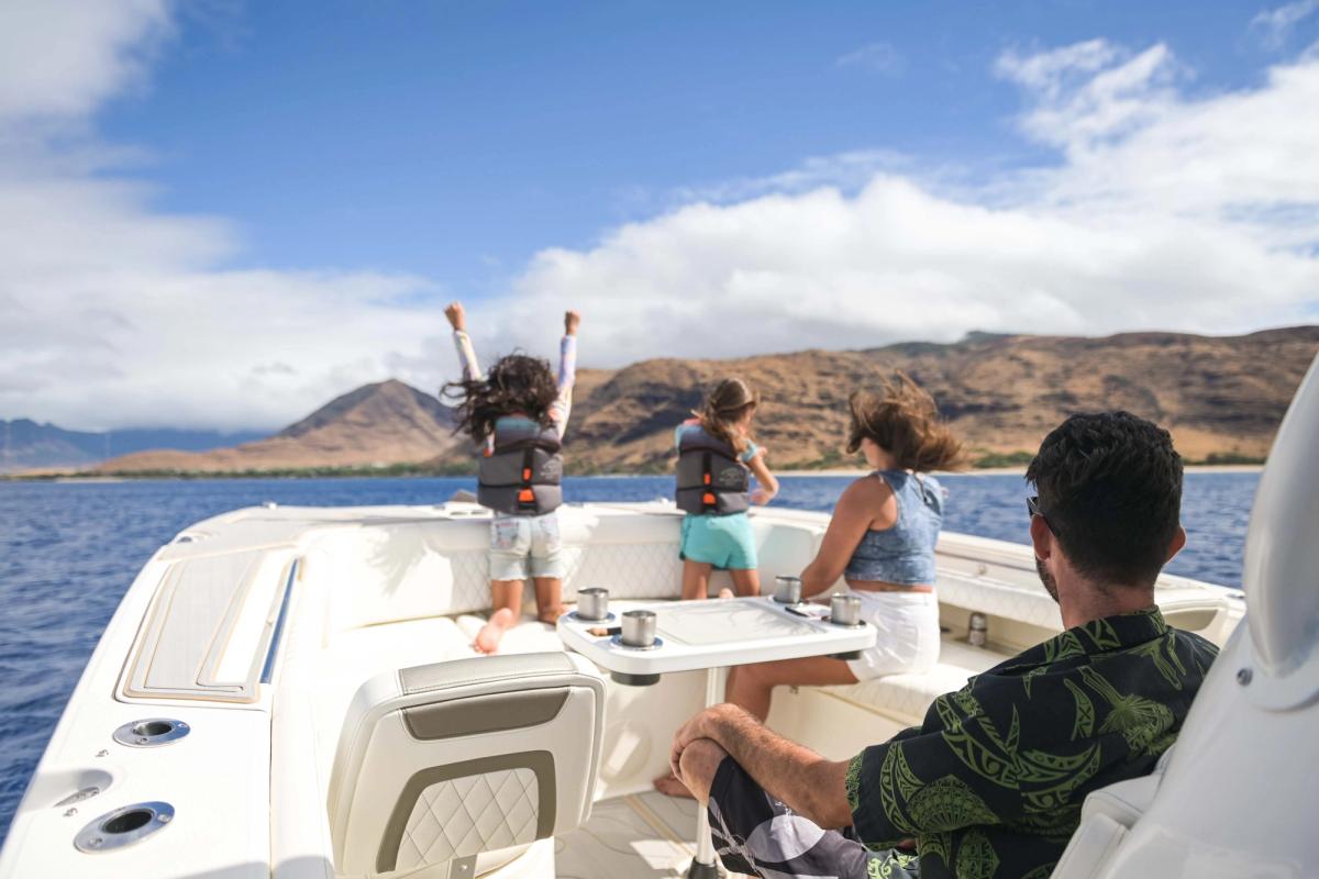 Guests on deck with Ko Olina mountains