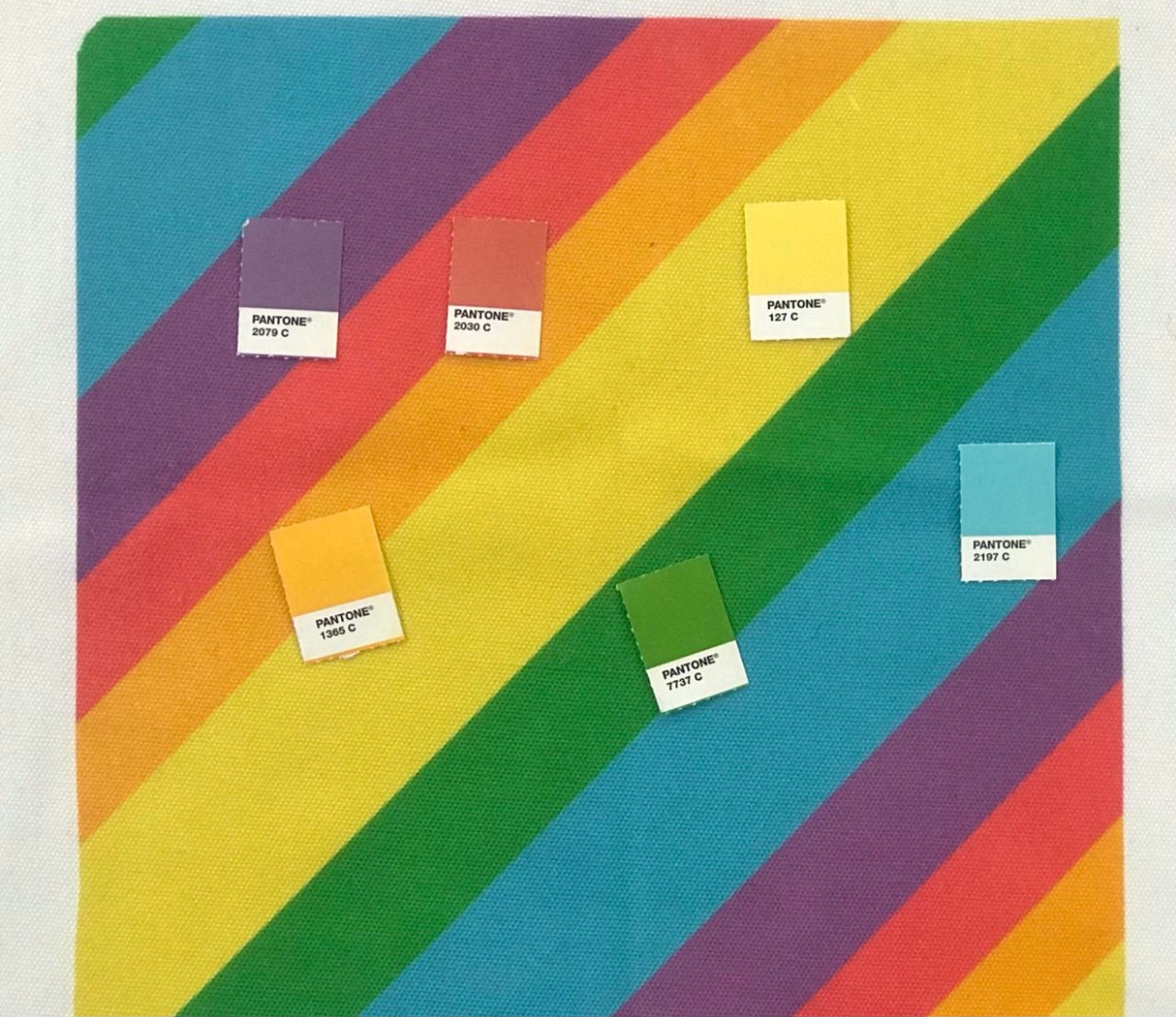 Rainbow diagonal stripes with five Pantone color swatches labeled with codes.