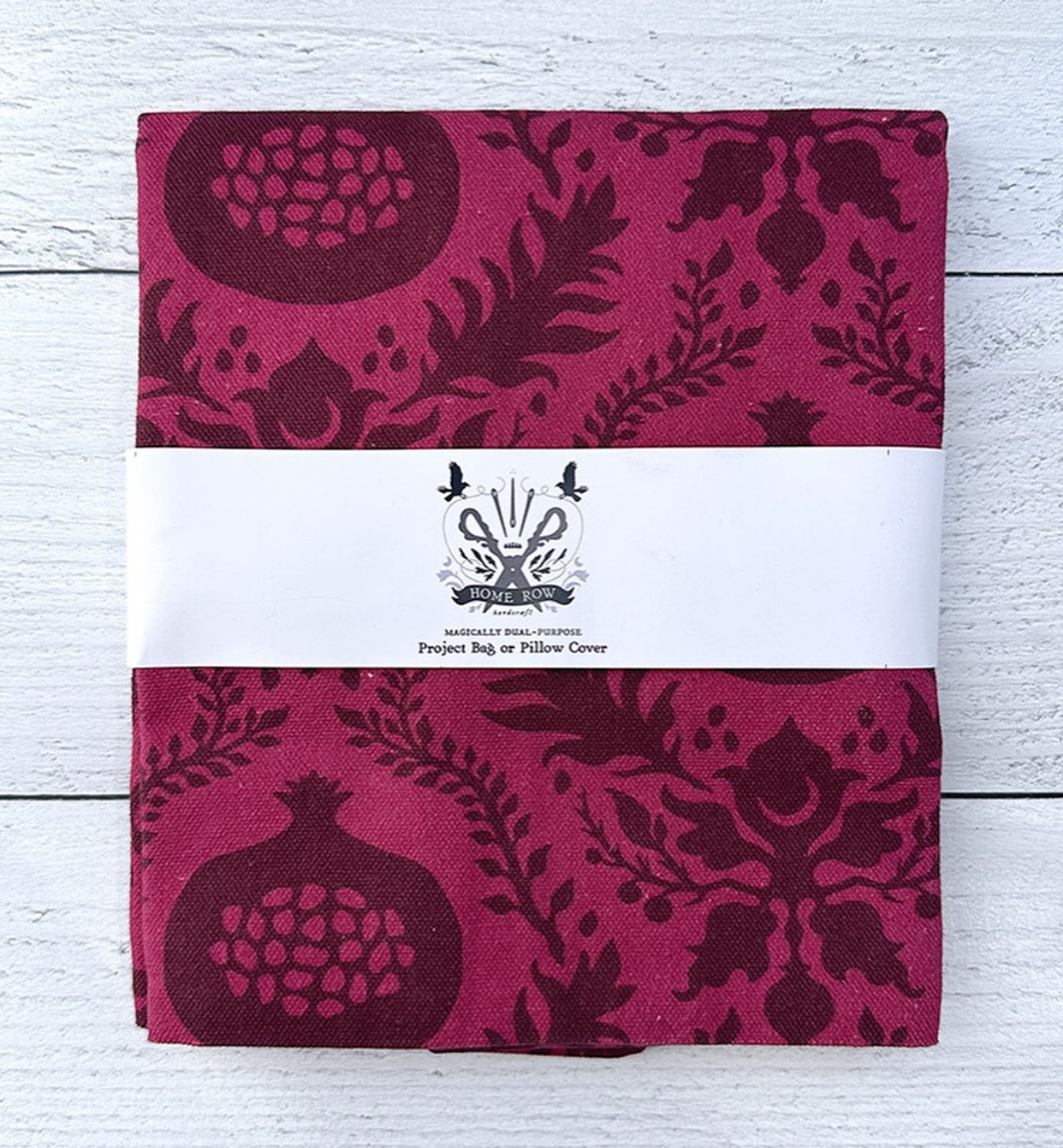 Magically dual-purpose burgundy project bag or pillow cover with botanical pattern, Home Row branding.