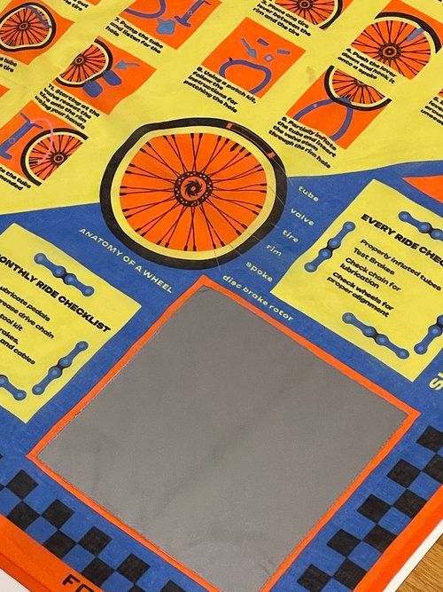 Colorful educational materials about bicycle wheels displayed on yellow and blue background.