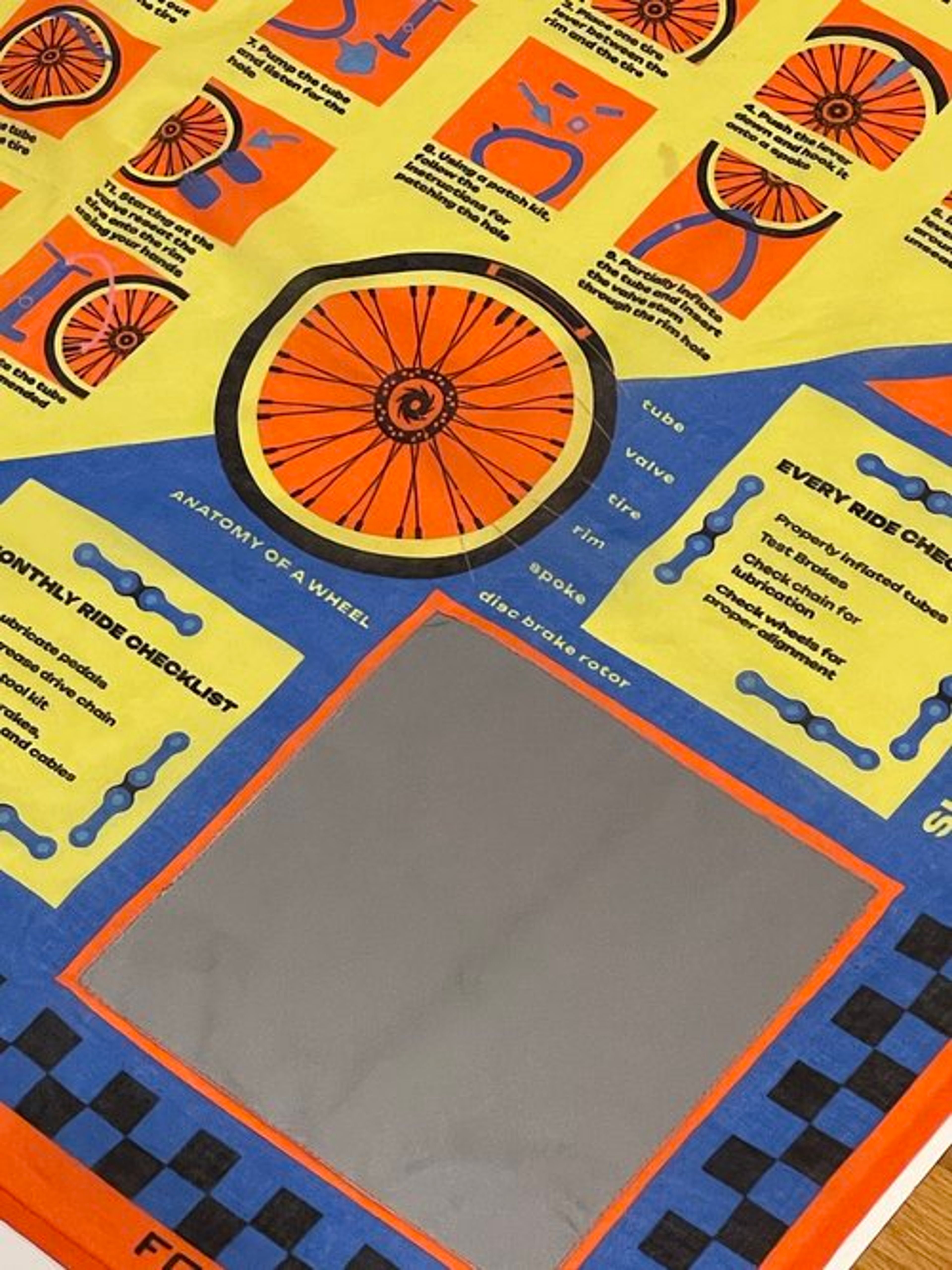 Colorful educational materials about bicycle wheels displayed on yellow and blue background.