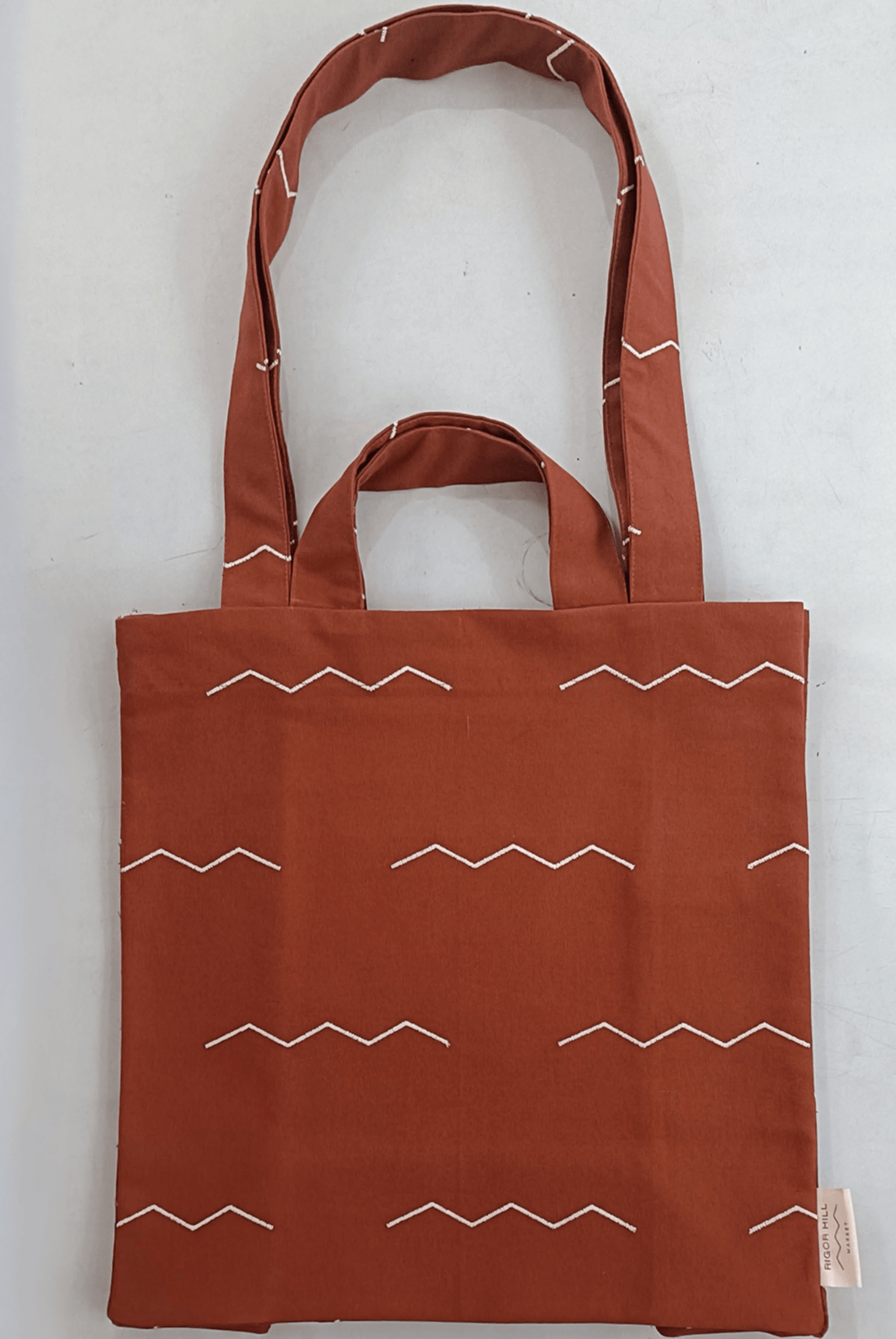 Canvas bag with embroidered brand mark