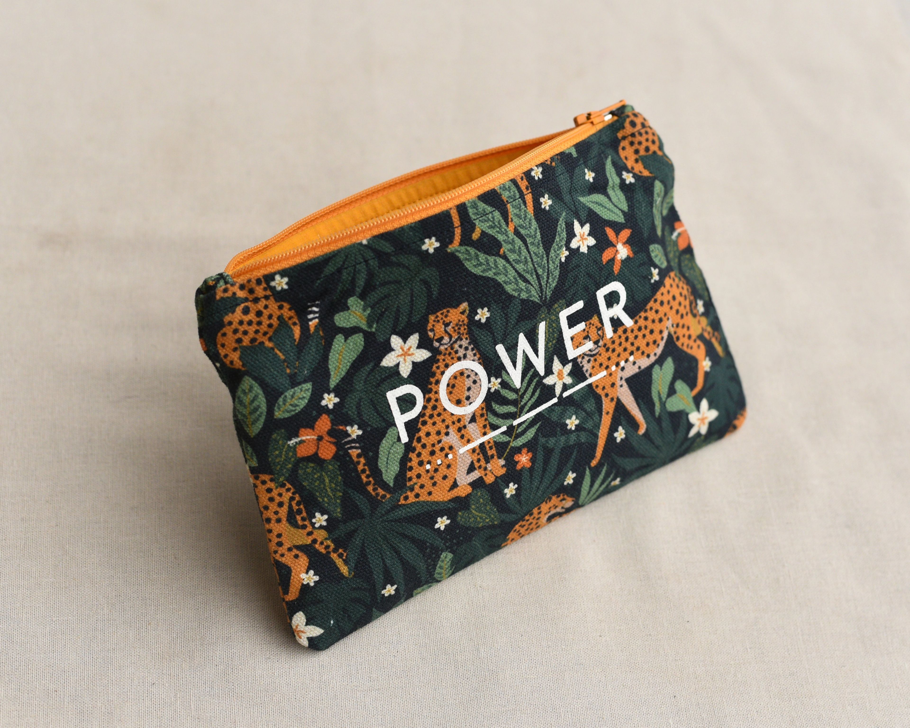 Zip Pouch with screen printed text over digitally printed artwork and color contrast zipper and poplin lining