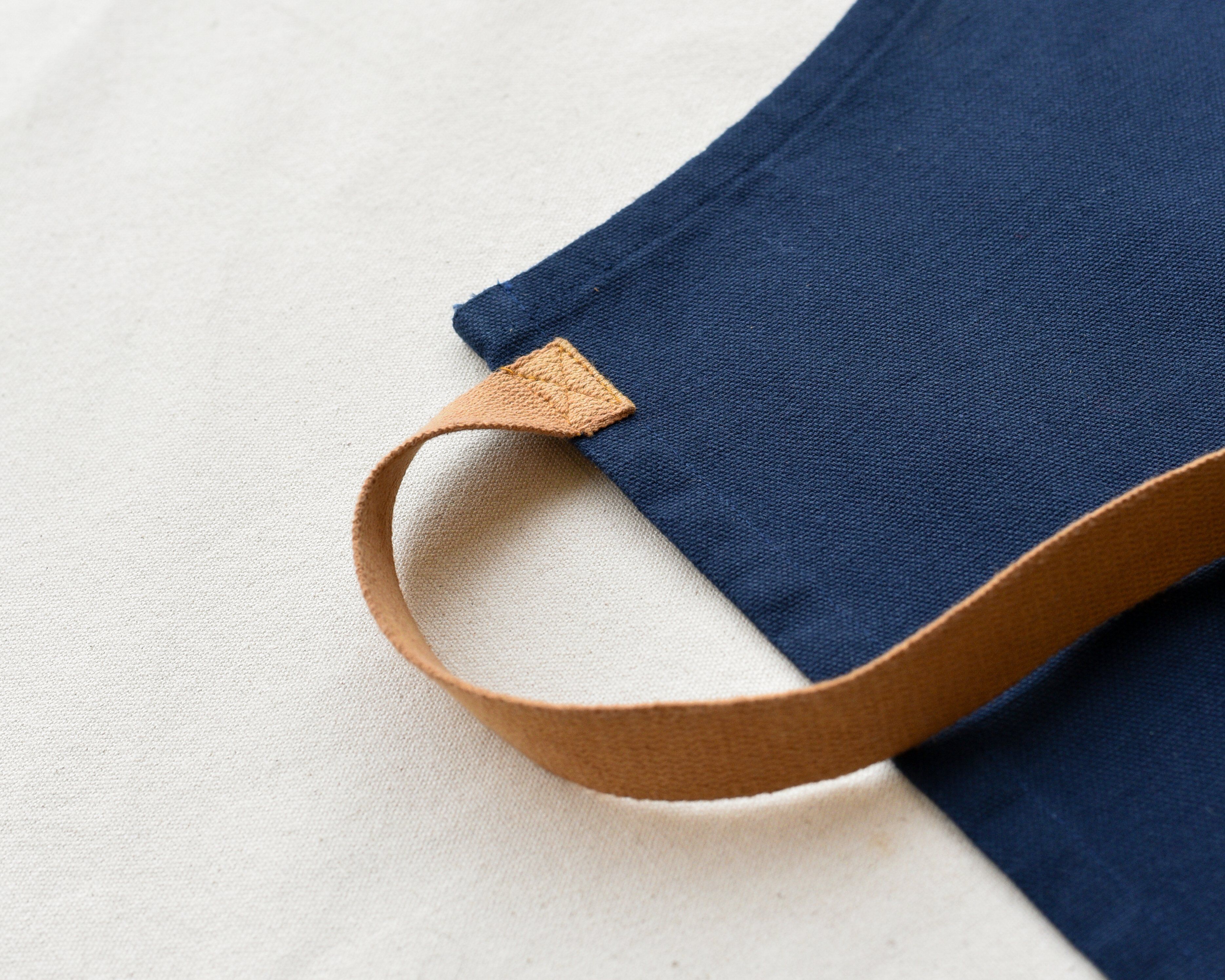 Apron waist strap attachment detail