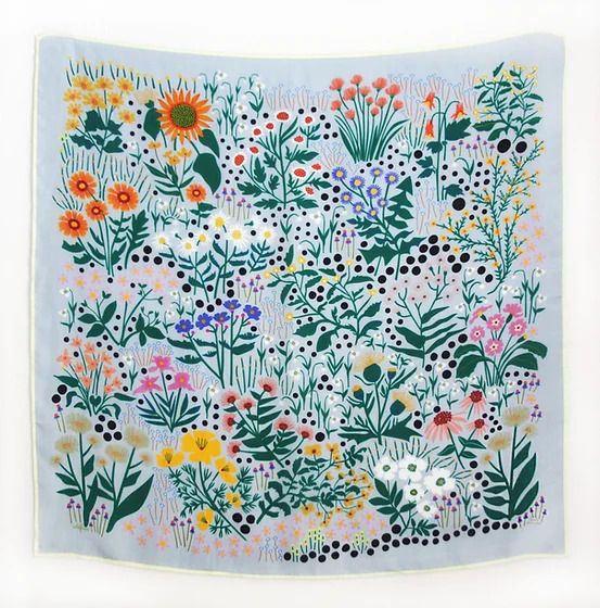 Colorful floral illustration featuring various wildflowers, plants, and botanical elements on light blue background.