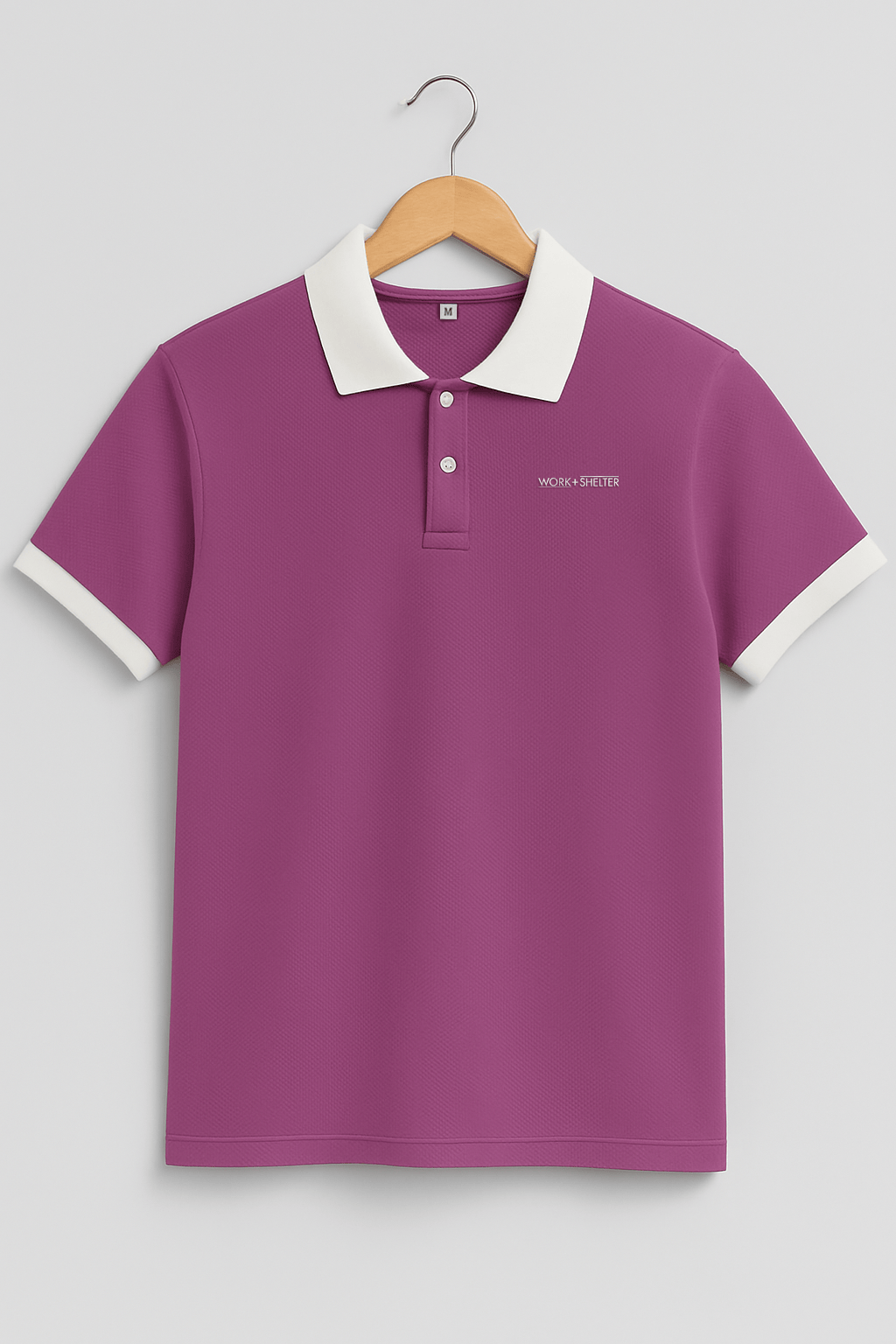 Purple polo shirt with white collar and cuffs on wooden hanger.