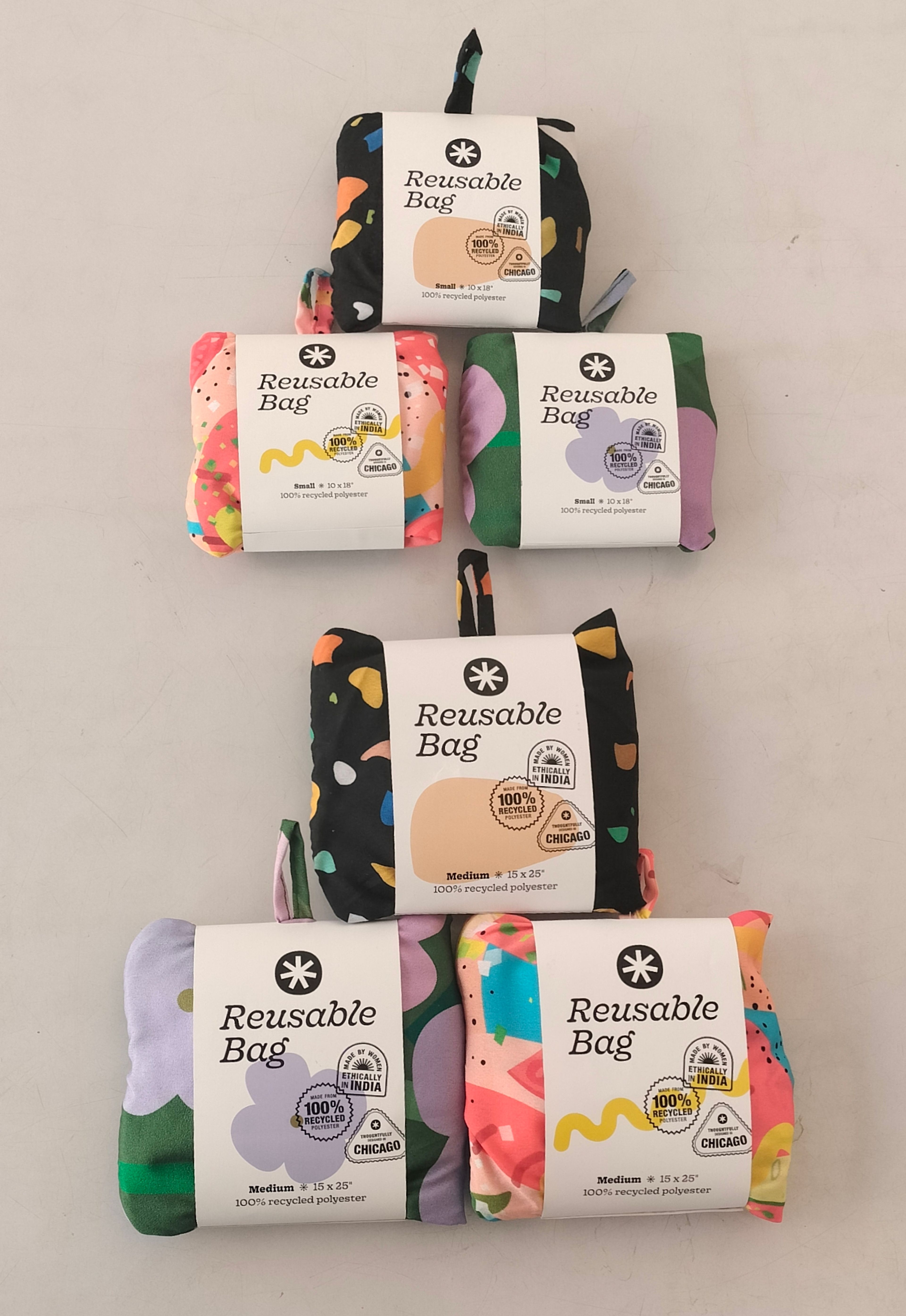 Six colorful reusable bags displayed in rows, showing various patterns and sizes.