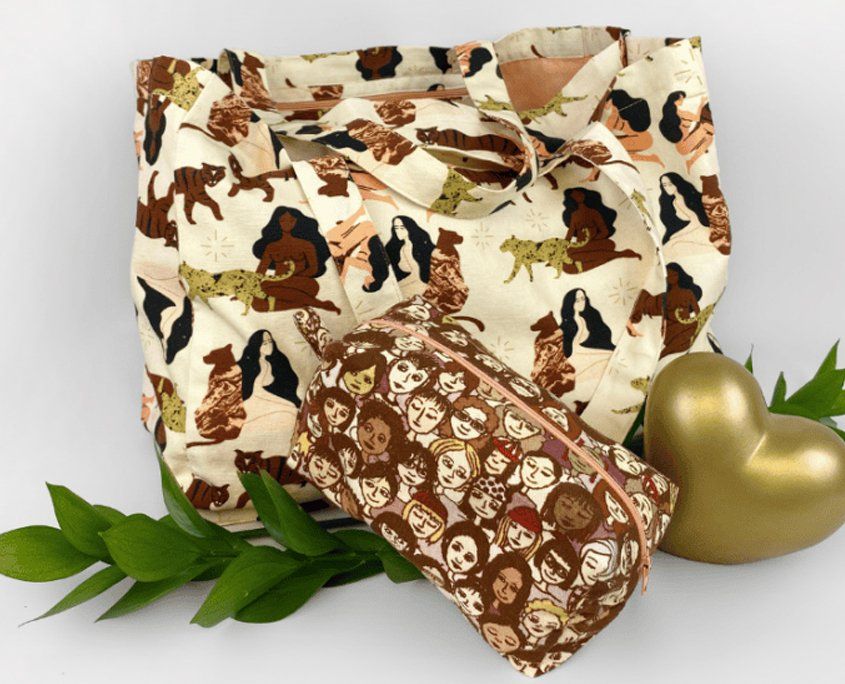 Decorative fabric tote bags with brown prints, gold ornament, and green foliage.