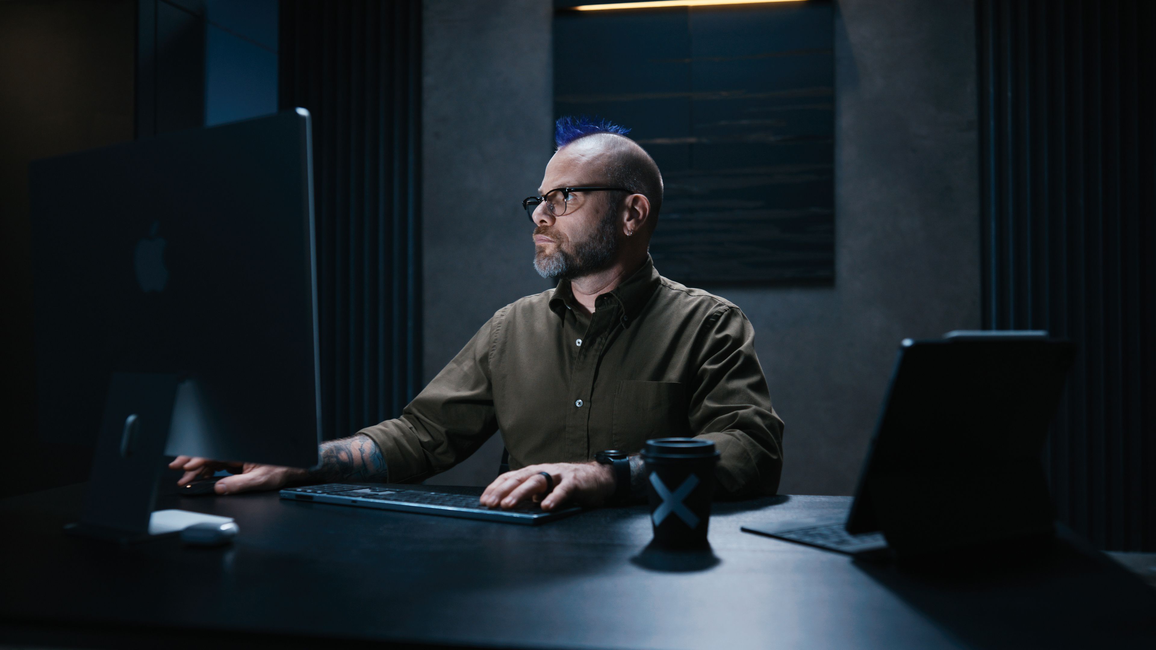 Person using a computer at their desk.