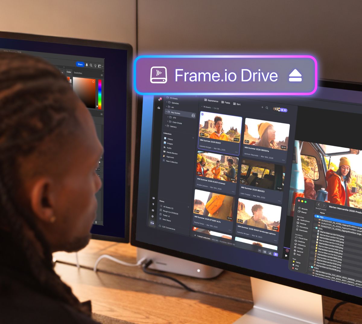 A person views dual computer monitors, the right displaying a glowing "Frame.io Drive" banner above video thumbnails.