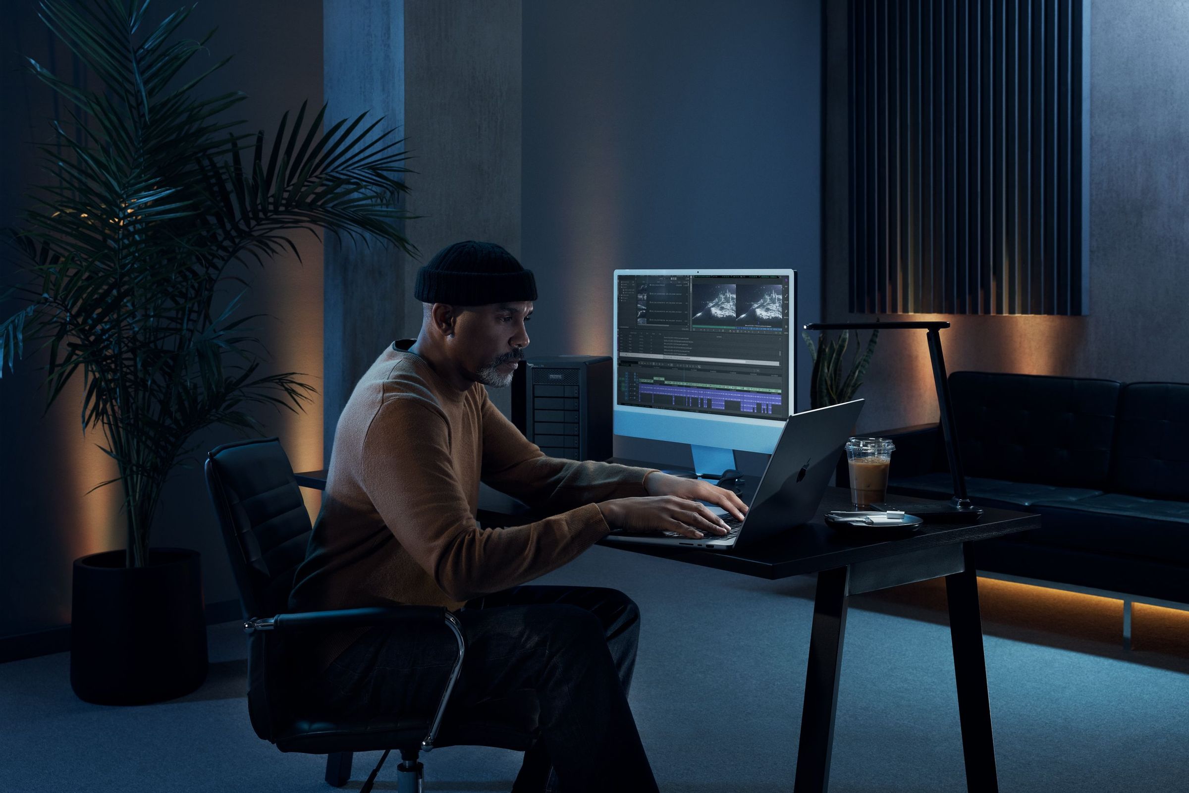Female editor working on a multiple monitor station