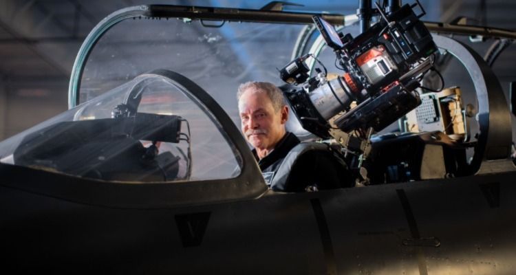 Person in jet cockpit with camera filming them.