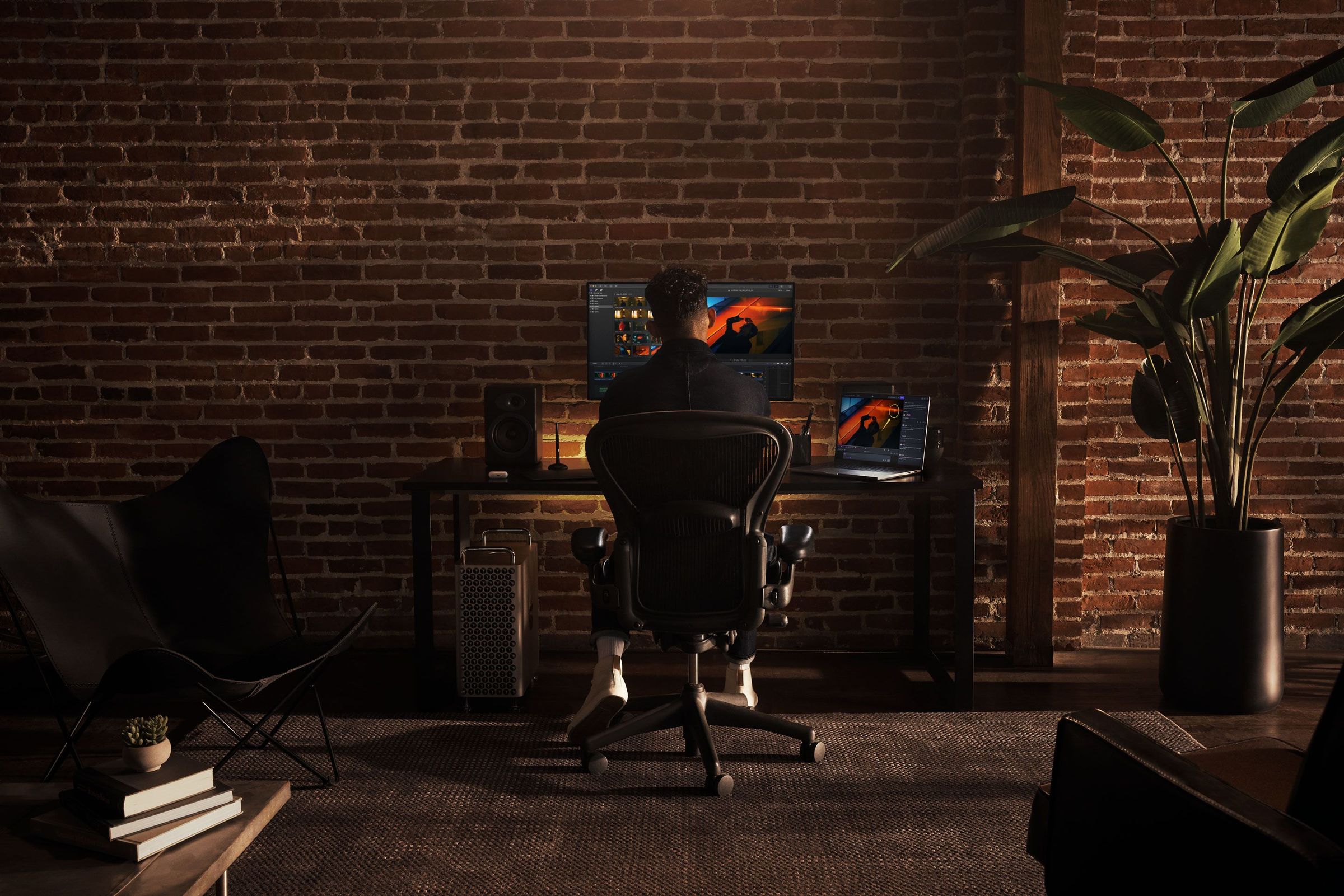 Female editor working on a multiple monitor station