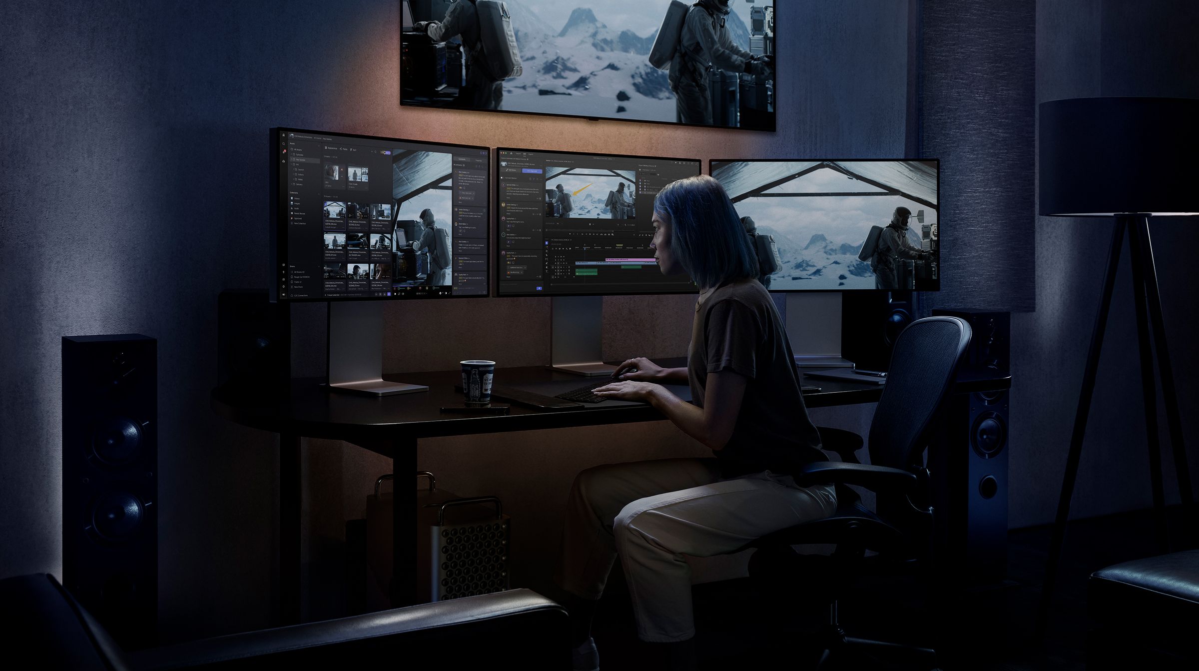 Female editor working on a multiple monitor station