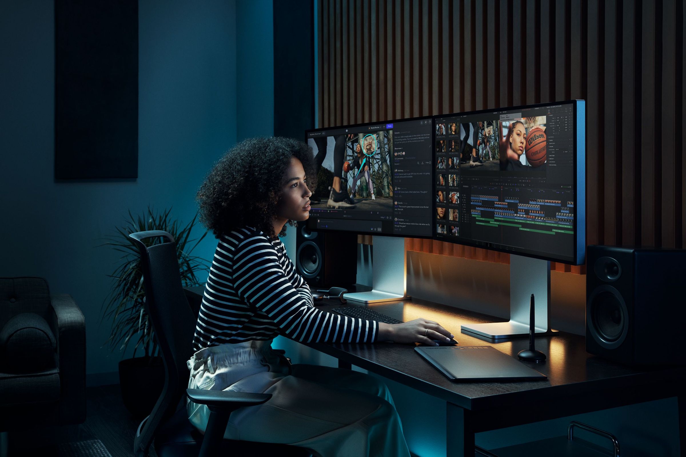 Female editor working on a multiple monitor station