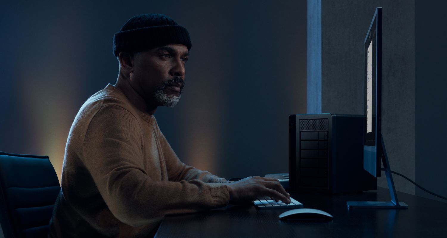 Person using a computer in a dark room.