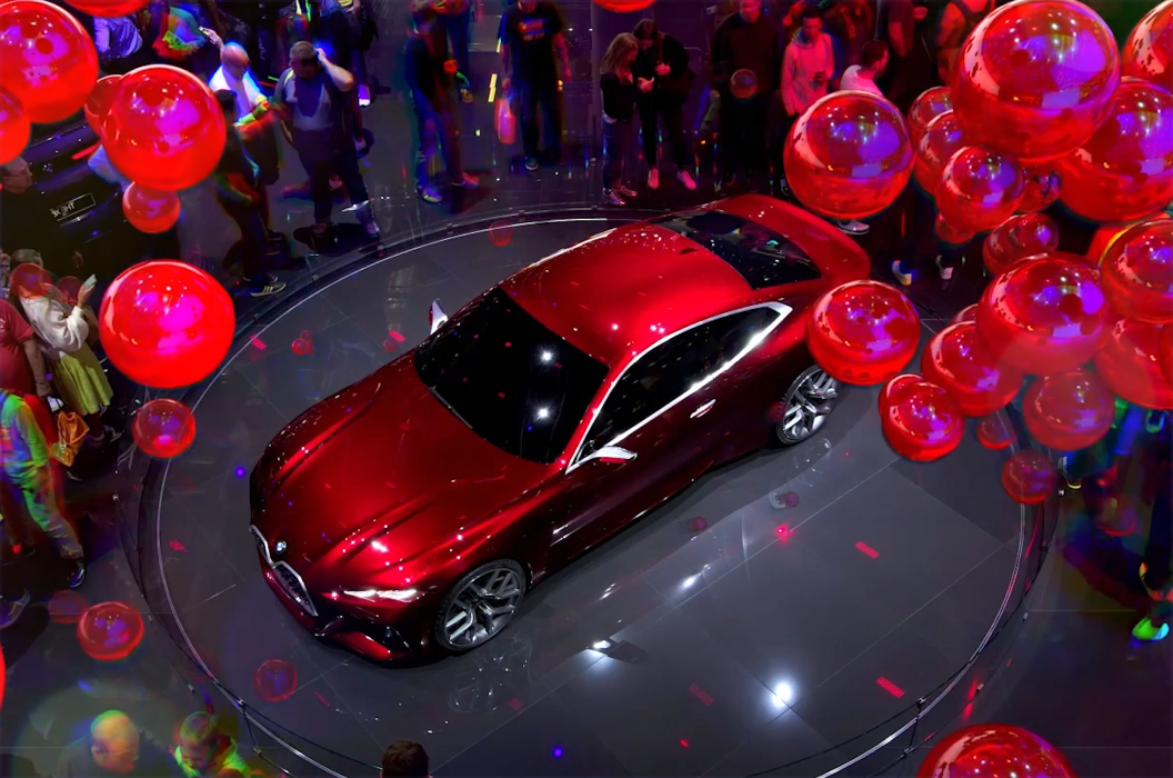 Car on display surrounded by balloons.