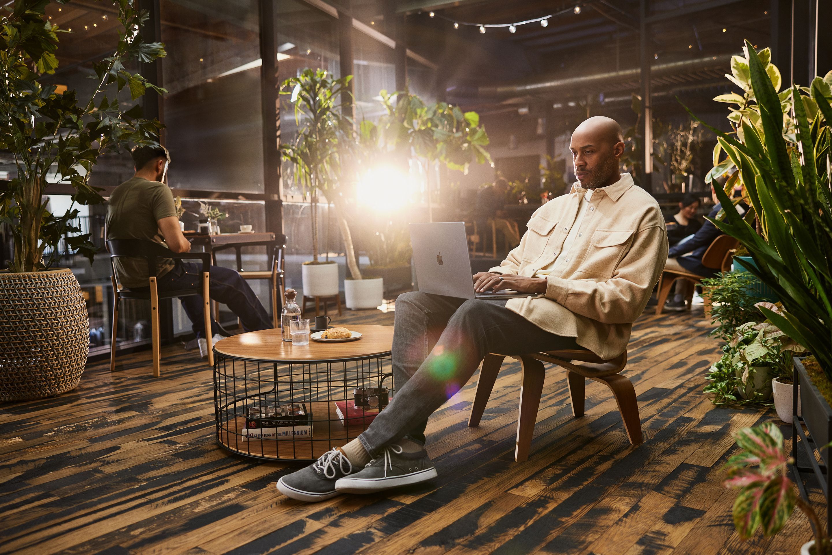 Person using their laptop in a coffee shop.