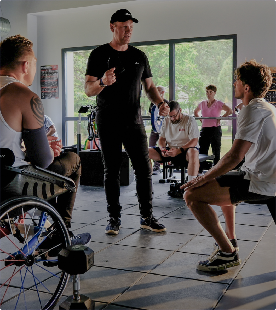 Coach training people in a gym.