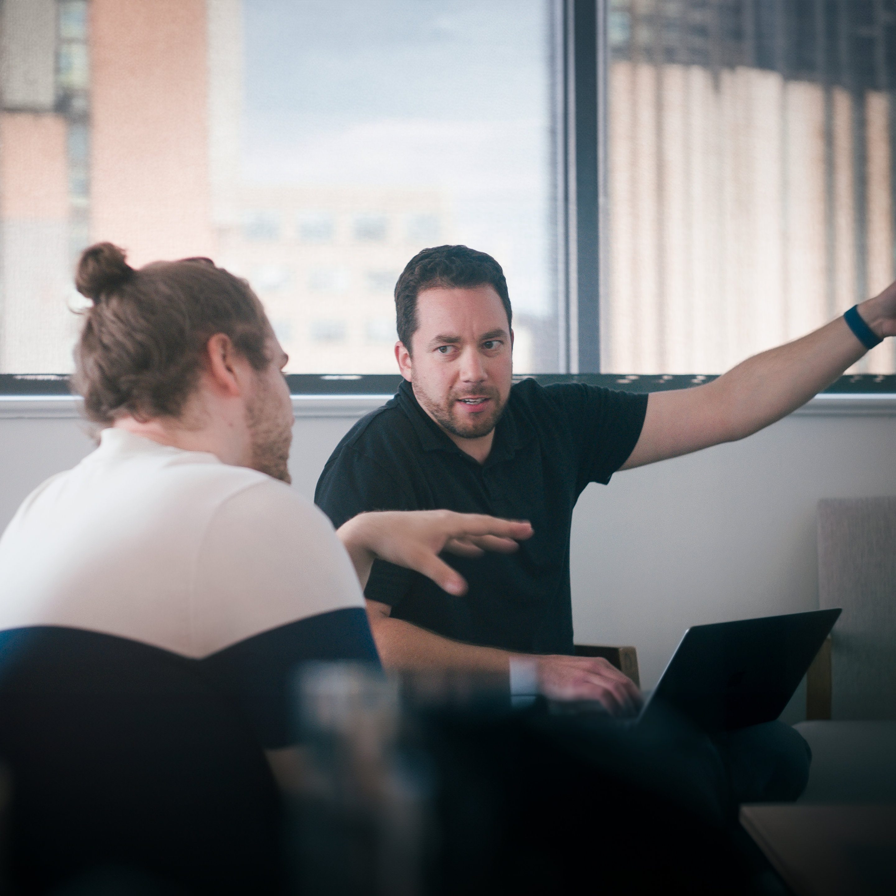Two people talking and gesticulating