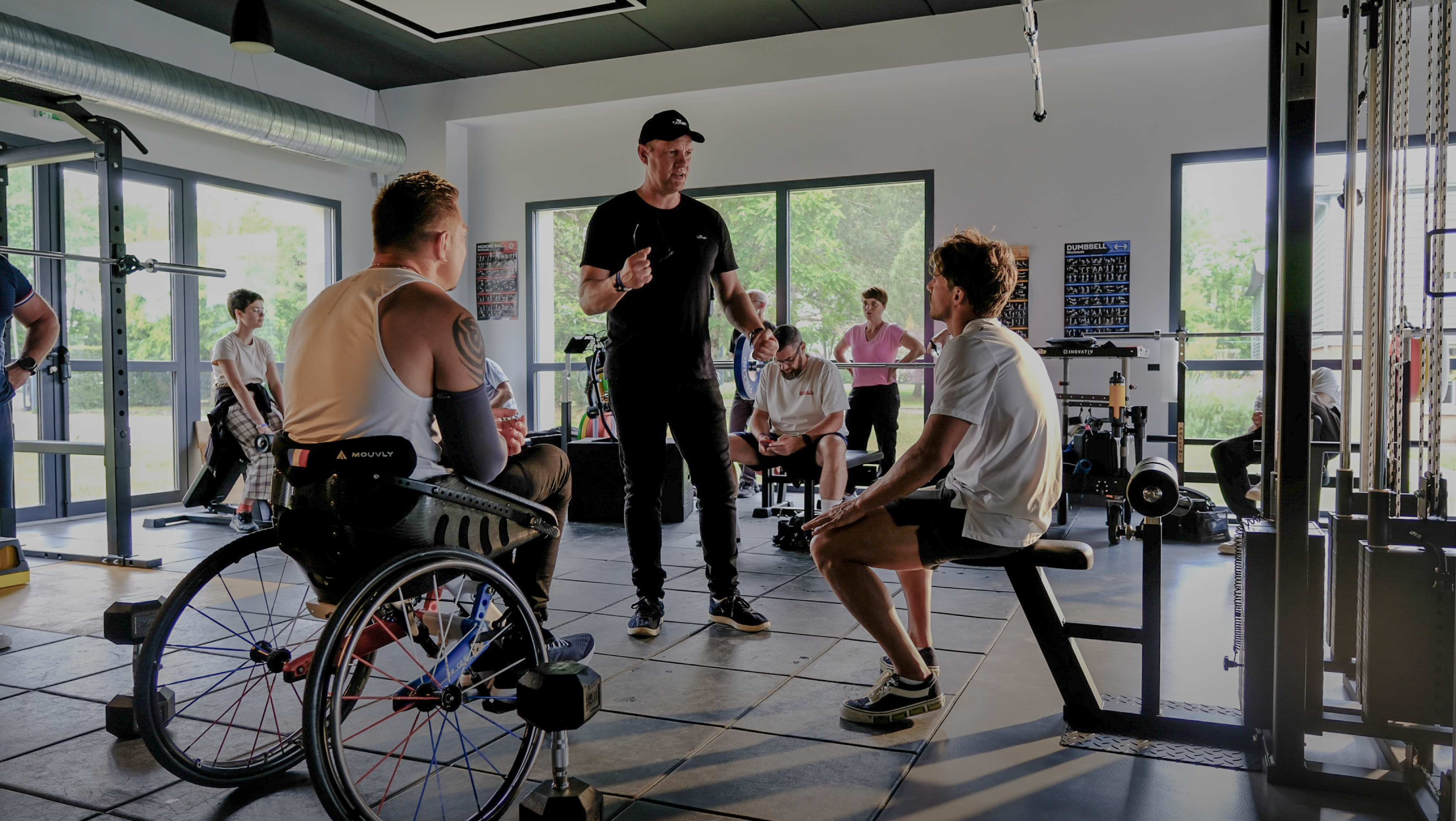 Coach training people in a gym.