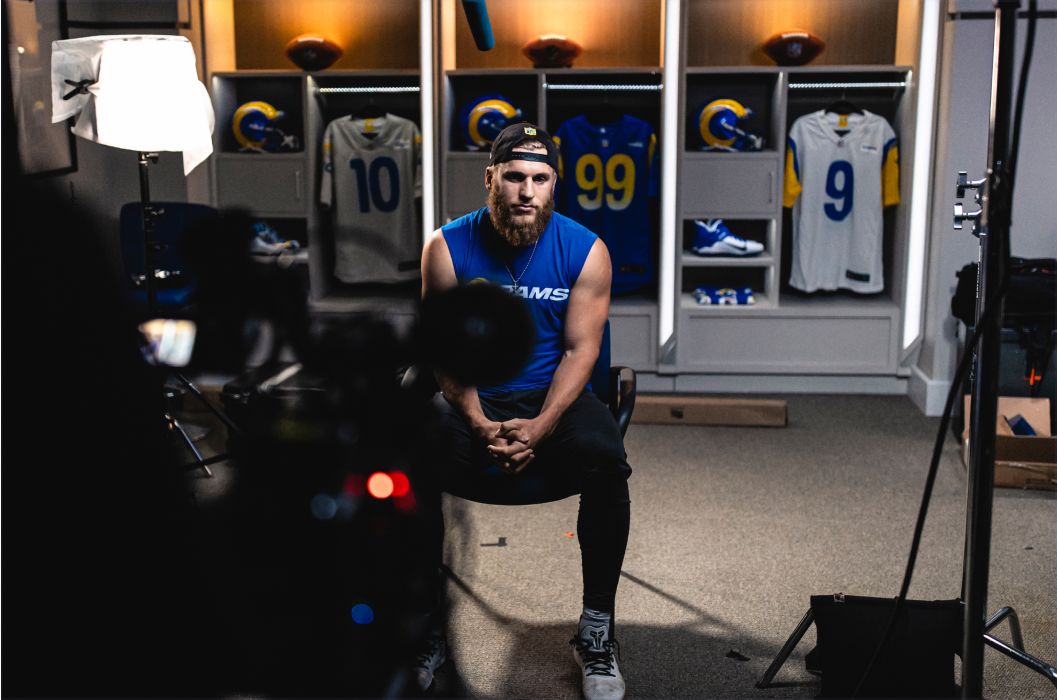 Athlete being interviewed in locker room.