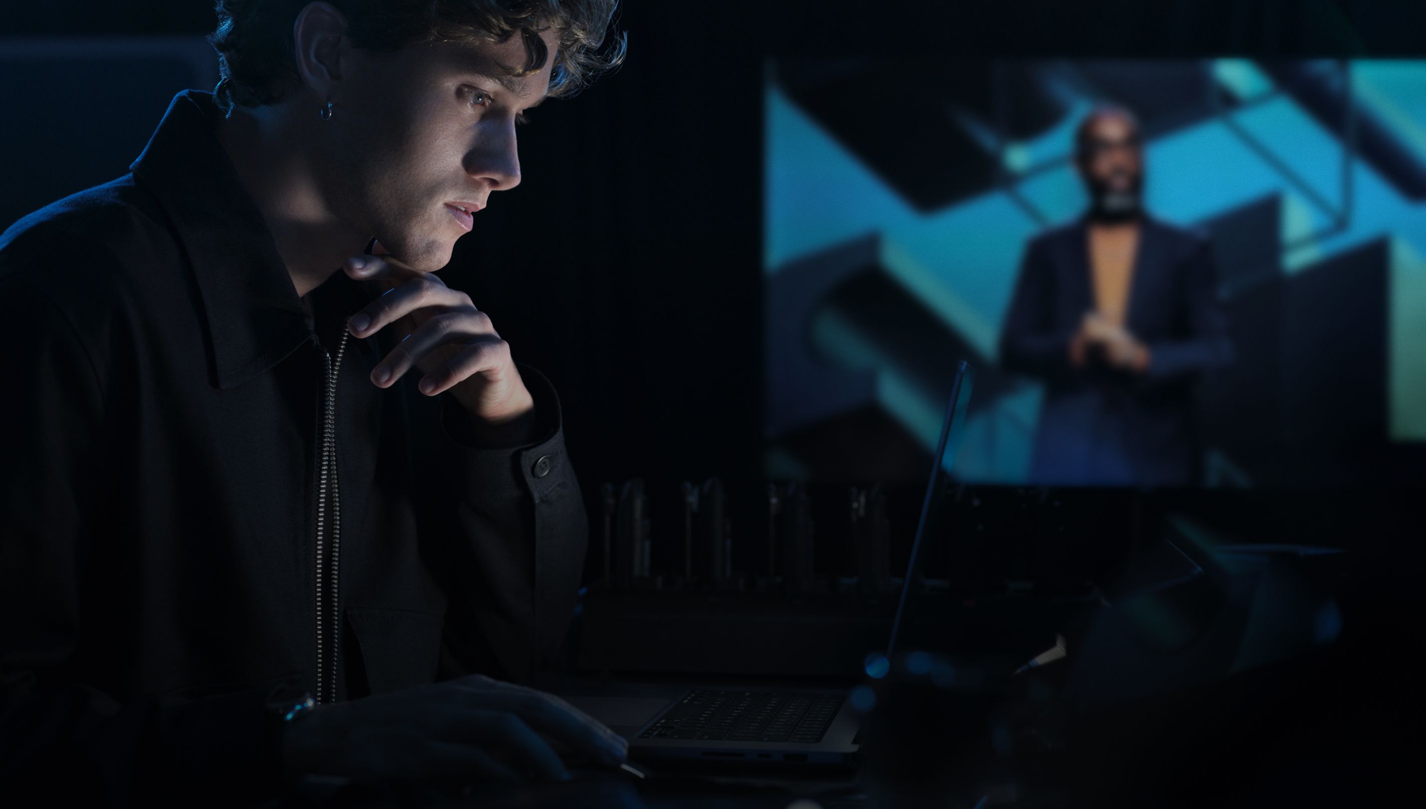 Person using a laptop during a conference