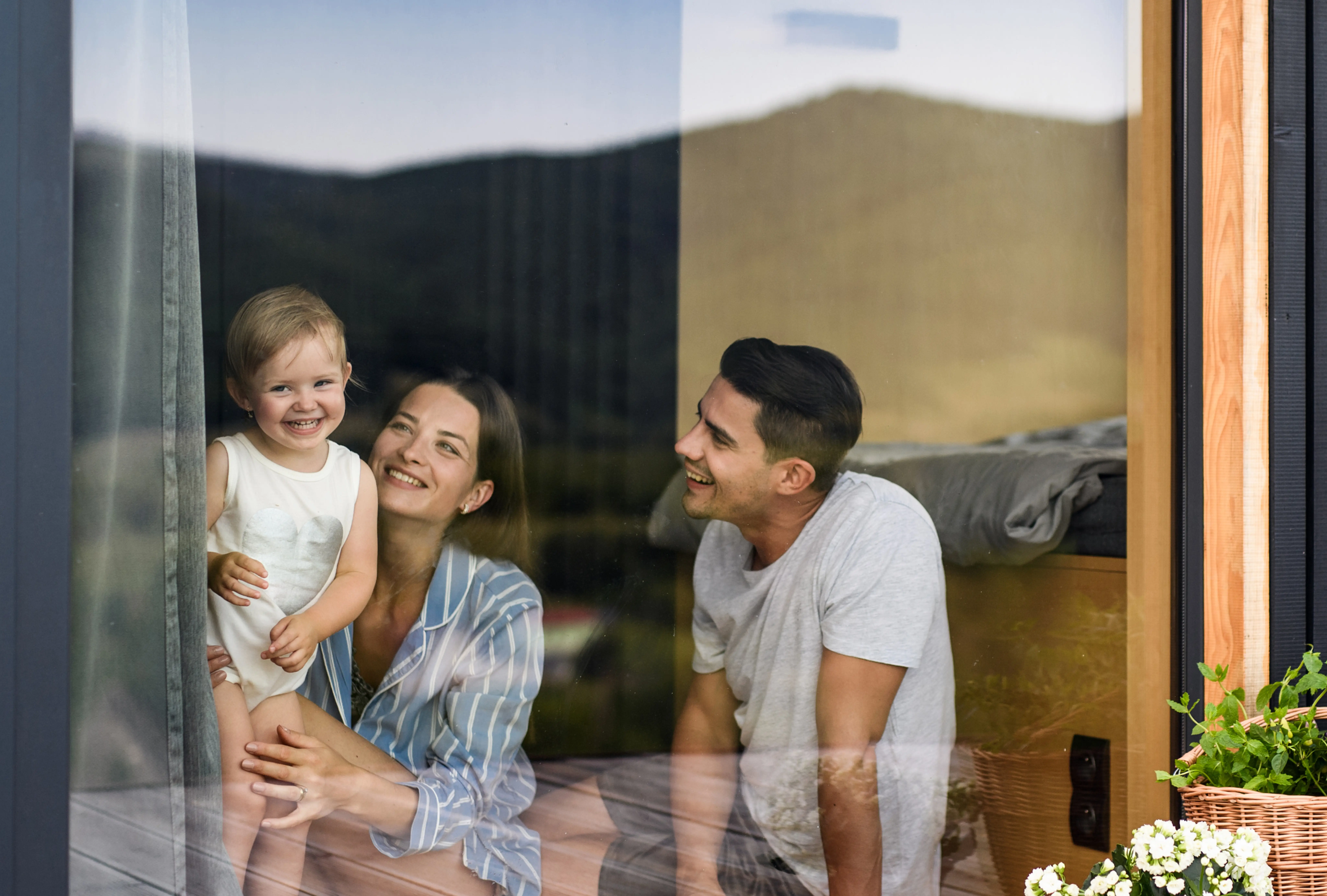 Parents and child through the window of an investment property.