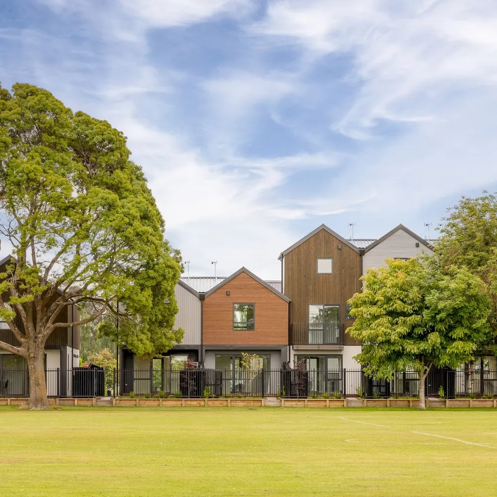 Investment townhouses viewed across a park