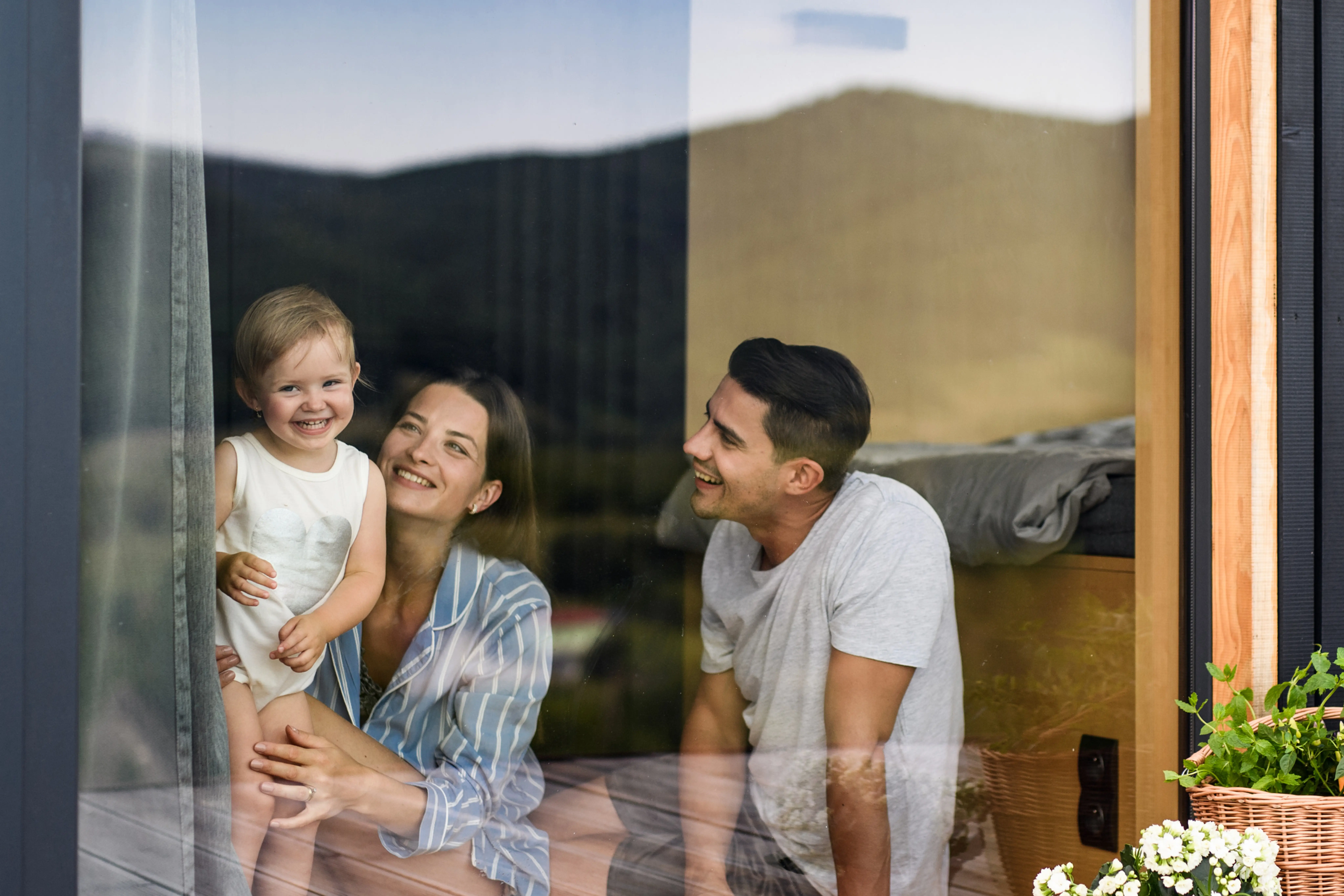 Parents and child through the window of an investment property.