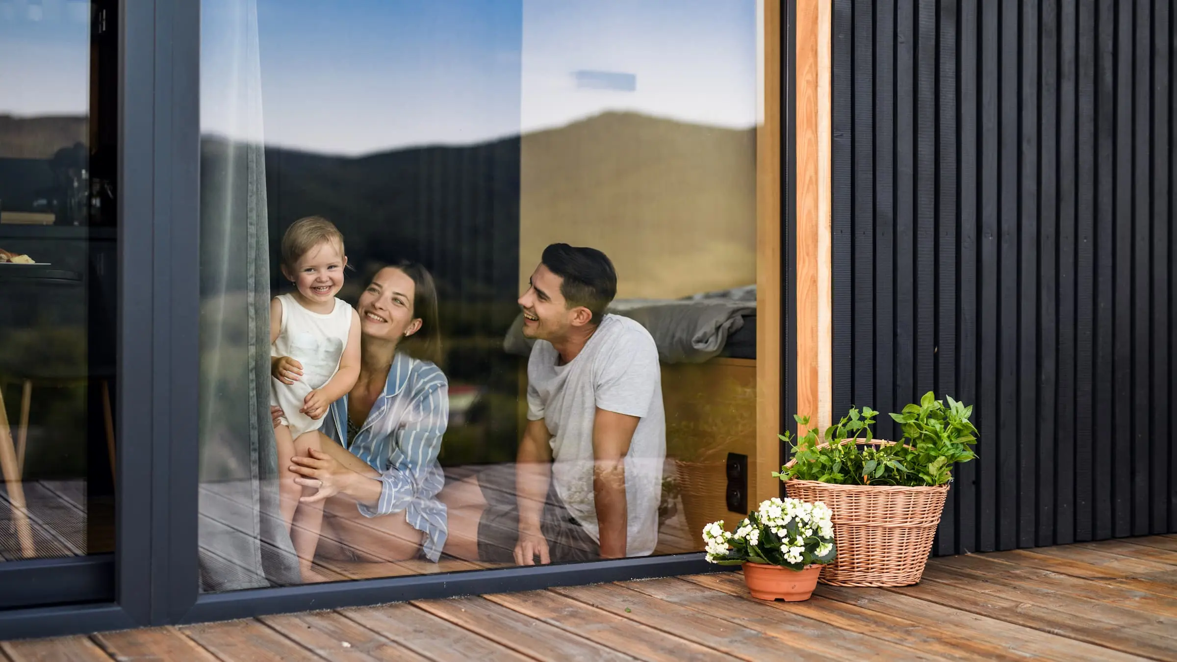 Parents and child through the window of an investment property.