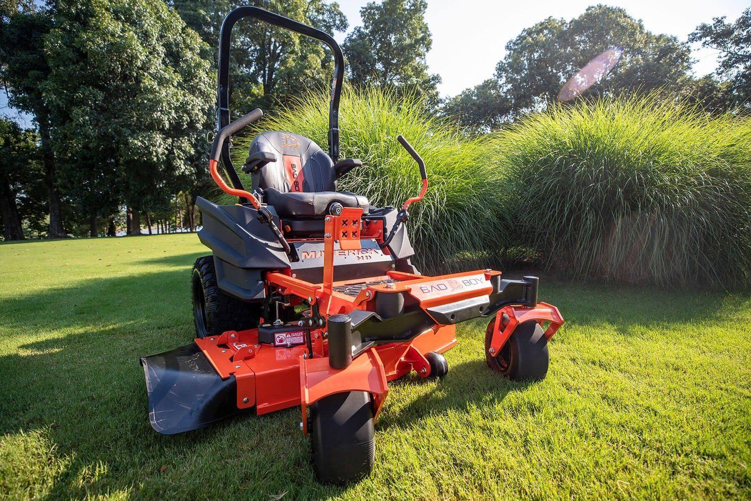 Bad Boy mower and UTV parked on gravel lot in Louisiana