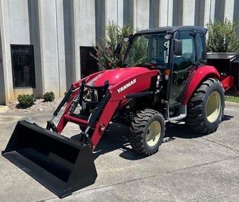 Yanmar tractors and UTVs parked in dealership lot