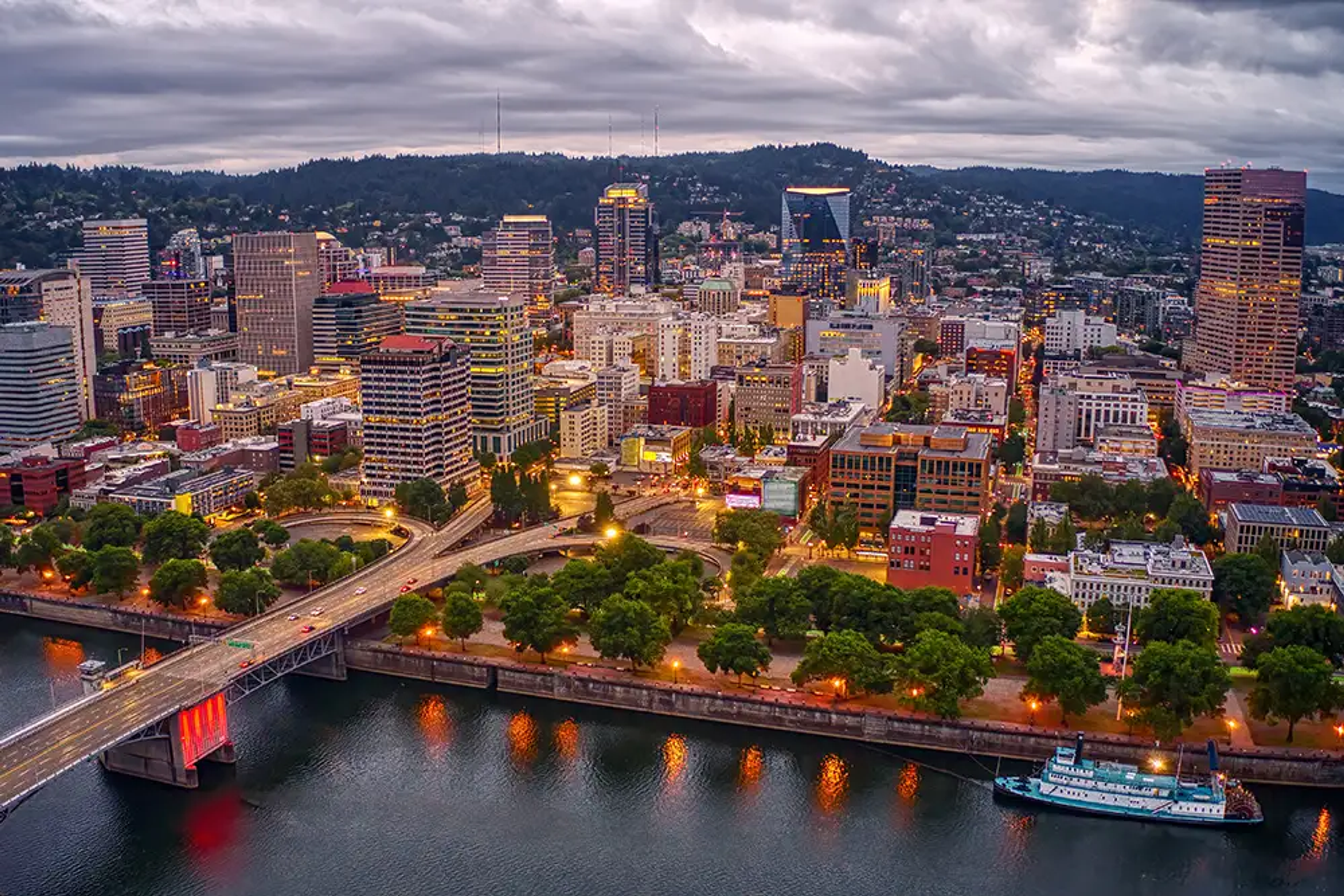 The Portland skyline at dusk, with the Willamette River and downtown bridges