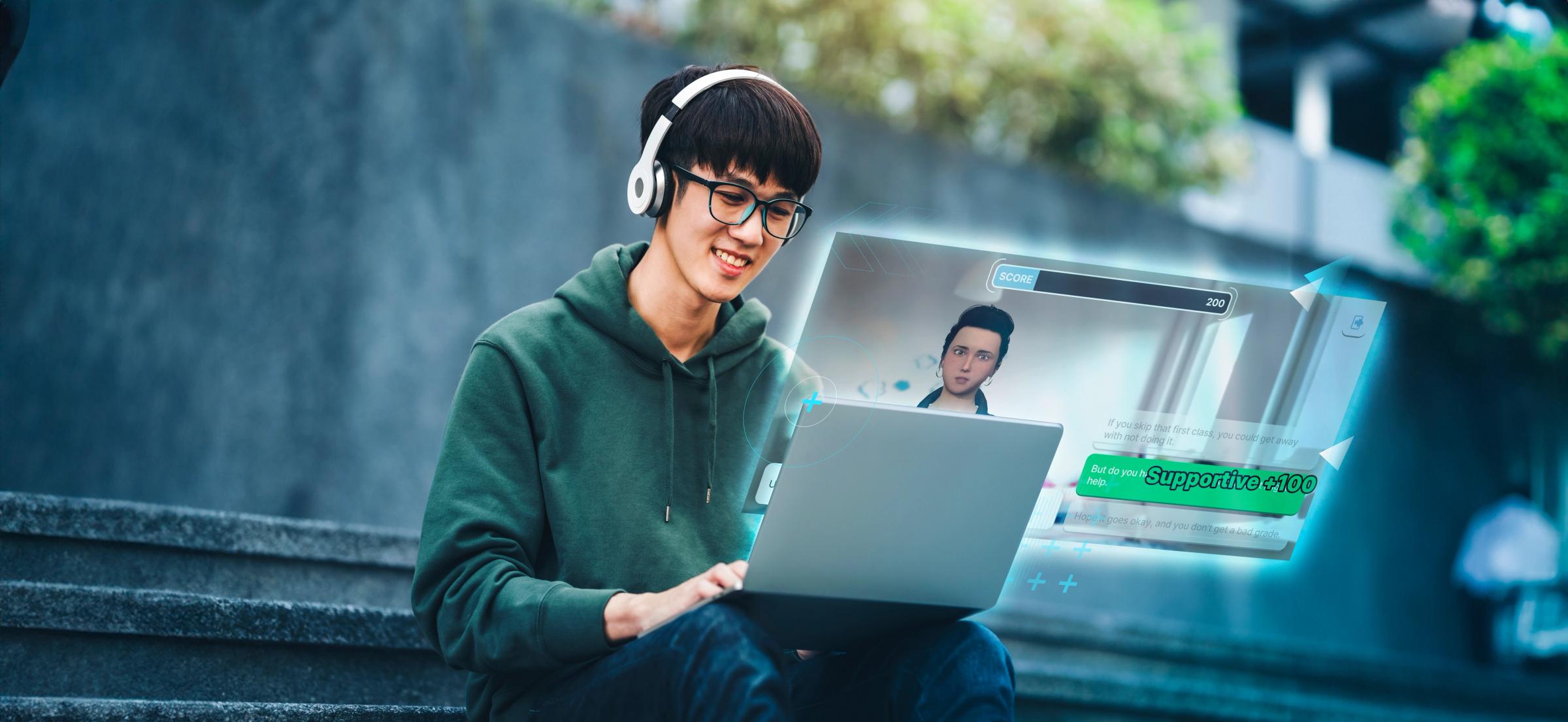 A young man with headphones and glasses smiles at a laptop displaying a futuristic holographic video call.
