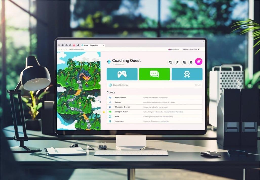 Desktop monitor on a desk showing a game-authoring tool with the project name Coaching Quest