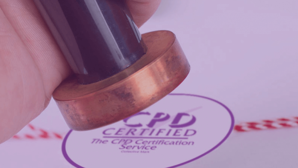 Hand pressing a stamp next to the CPD Certified mark from The CPD Certification Service