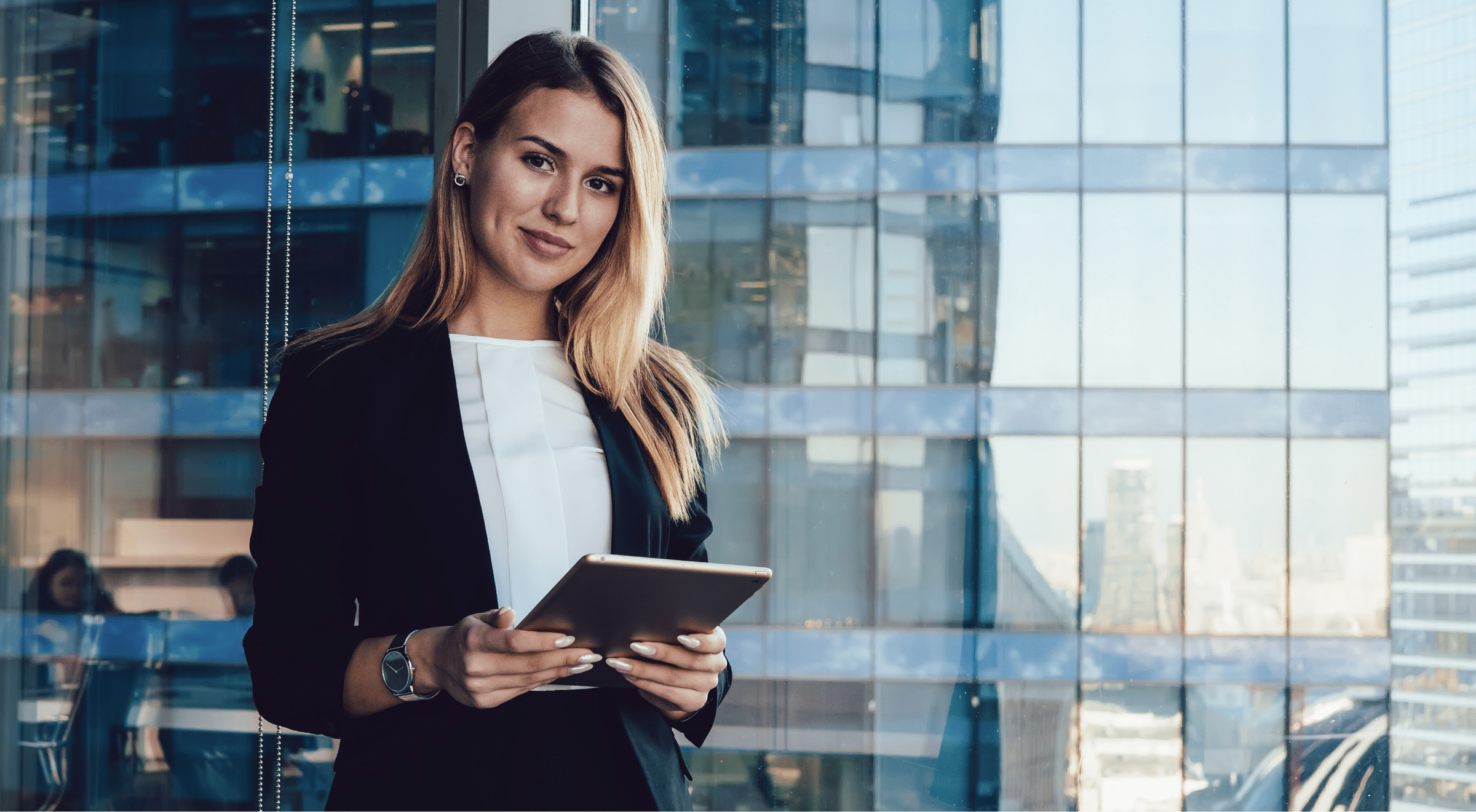 Mitarbeiterin im Finanzsektor lächelt mit einem Tablet