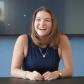 Emily Morgan, article author, laughing at a table in an office