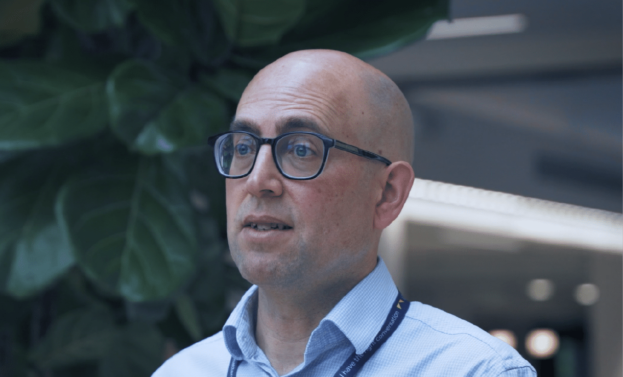 Andrew Crowe von der Leeds Building Society spricht in einem Innenraum und trägt ein Lanyard