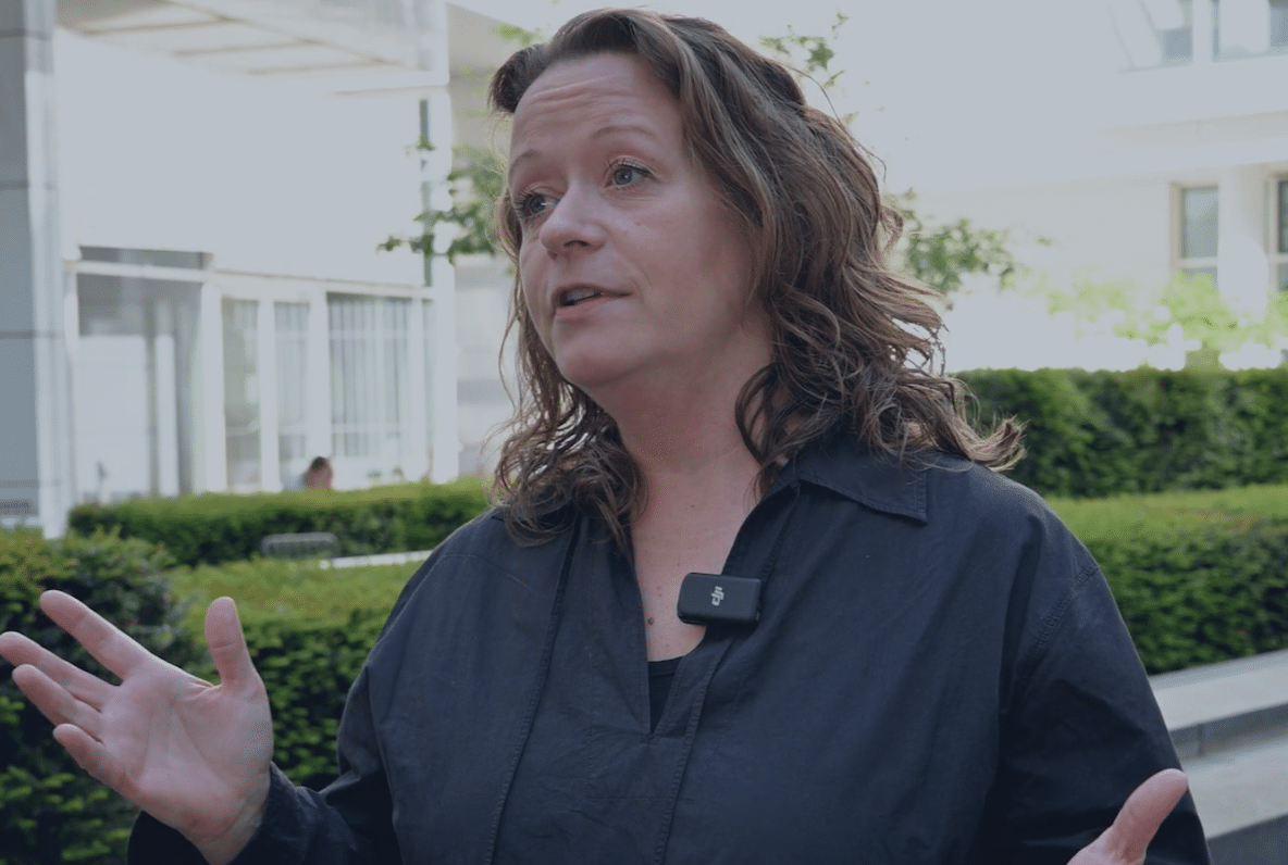 Annika Mersch of Vapiano speaking to camera outdoors, wearing a clip-on microphone