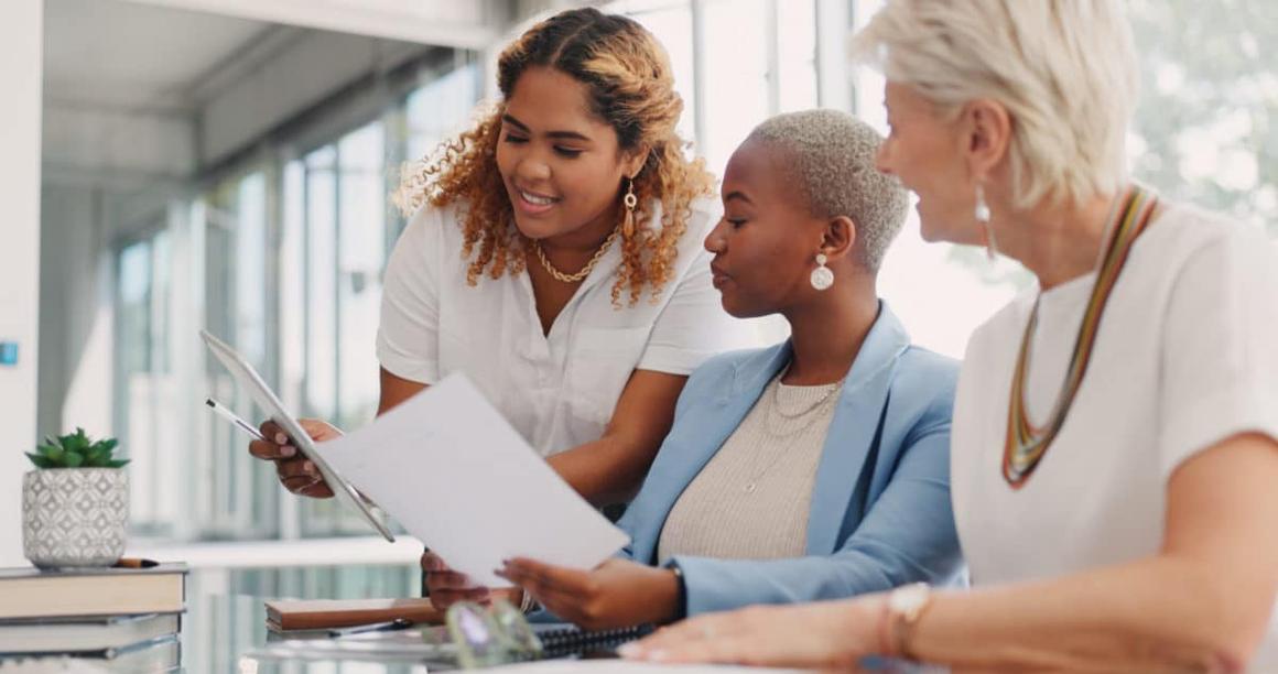 Chart, tablet or business people in a meeting planning kpi, strategy or analytics paperwork for data analysis. Documents, team work or employees in communication or speaking of goals for sales growth.