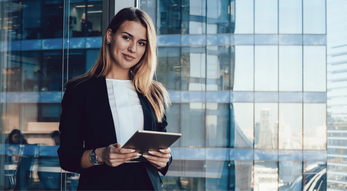 Financial services woman on ipad standing and smiling