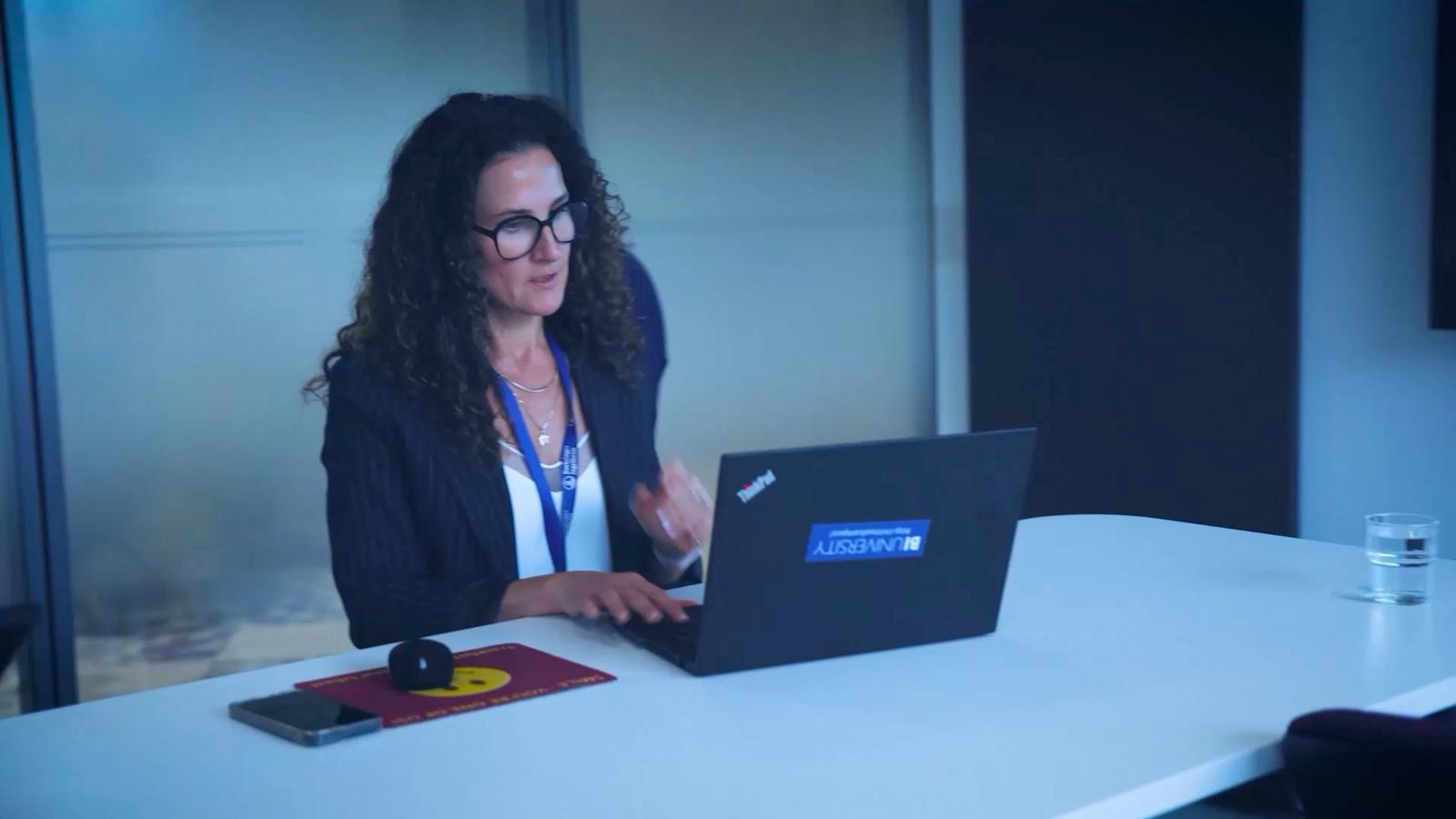 Woman looking at computer in office setting