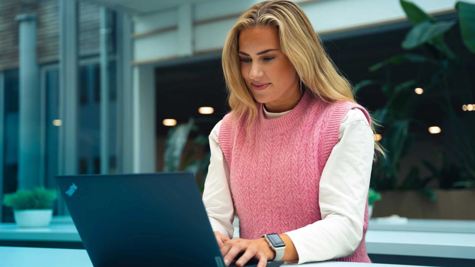 Woman looking at computer in office setting