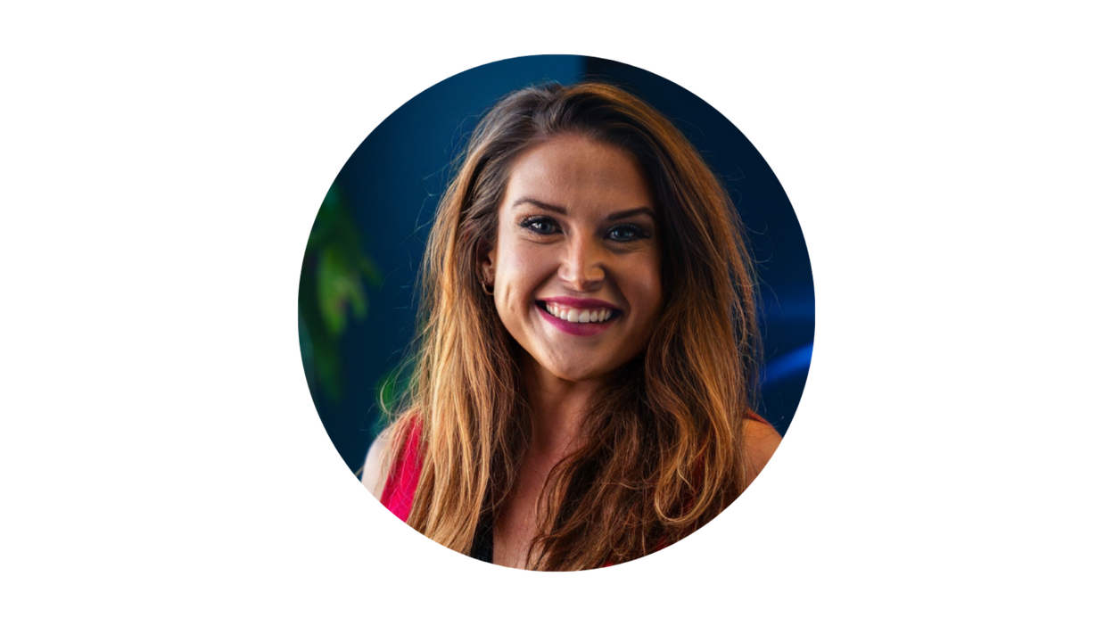 Siobhan Lipnicki smiling in a circular portrait, long wavy hair, dark background
