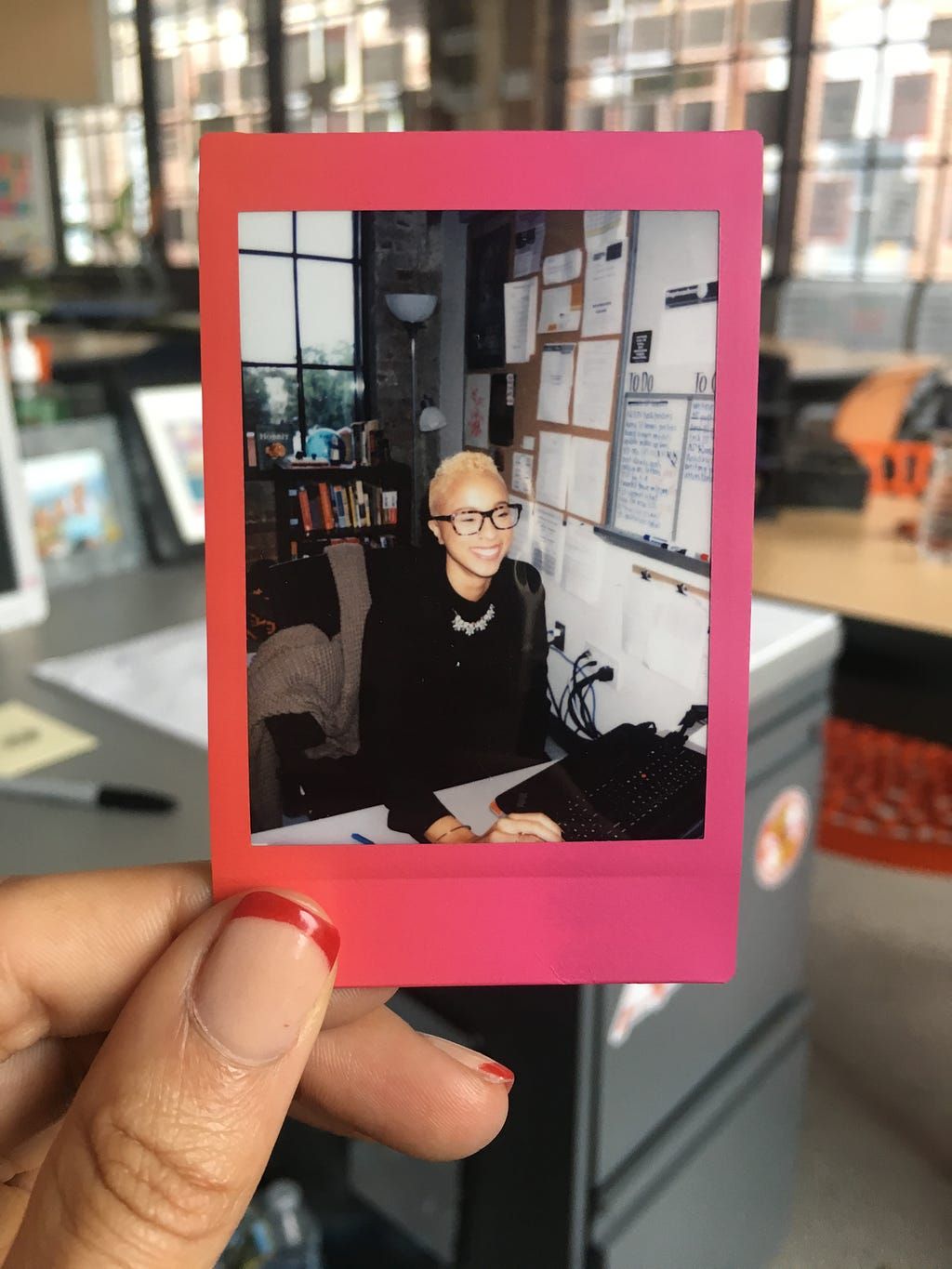 A polaroid of Erin in her classroom, taken in her classroom.