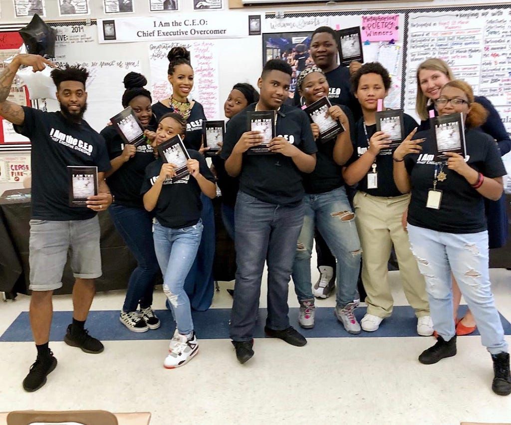 Former Curriculum for the Culture panelist Kyle Pompey (far left) with LaQuisha and her scholars at their book signing. You can purchase their book, ‘I am C.E.O’, on Amazon.