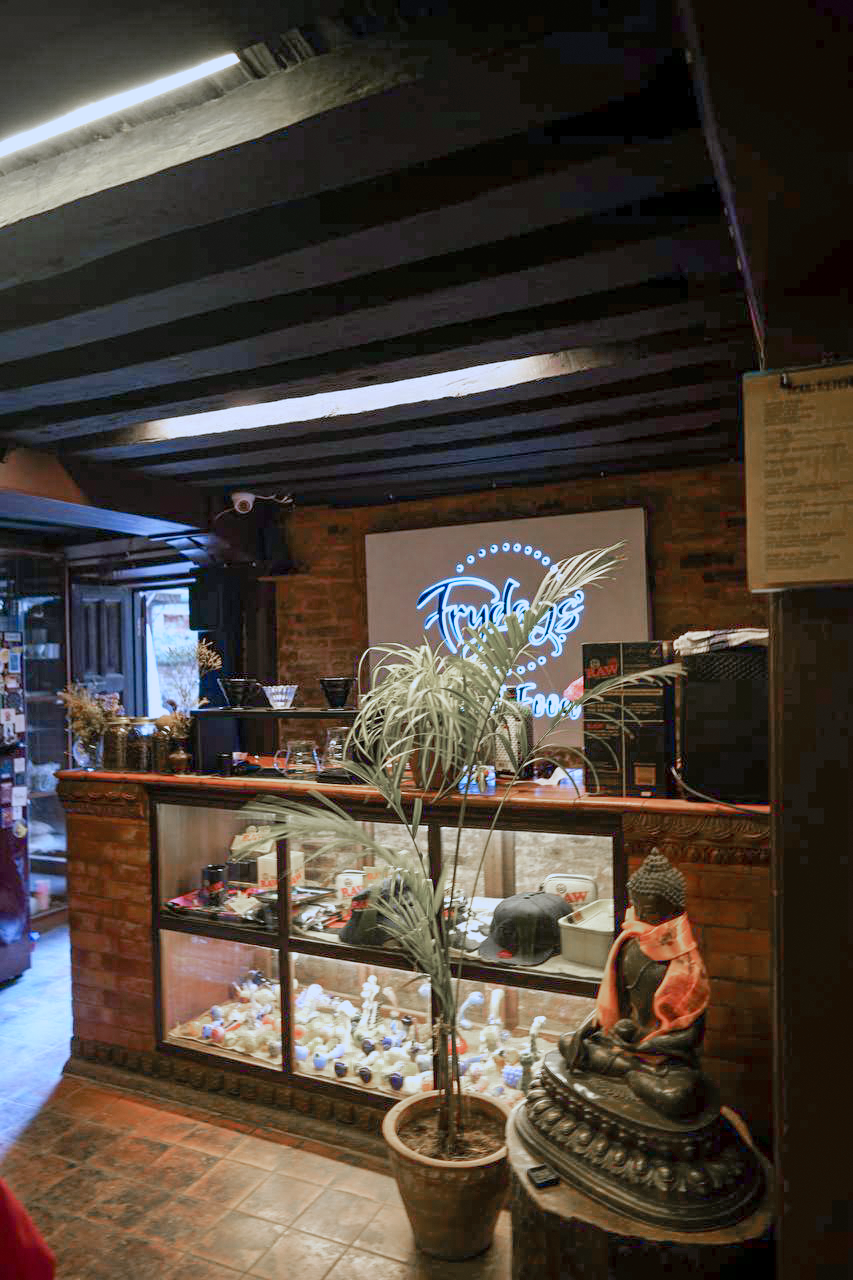 Tables inside the brick-walled Hiranya Cafe