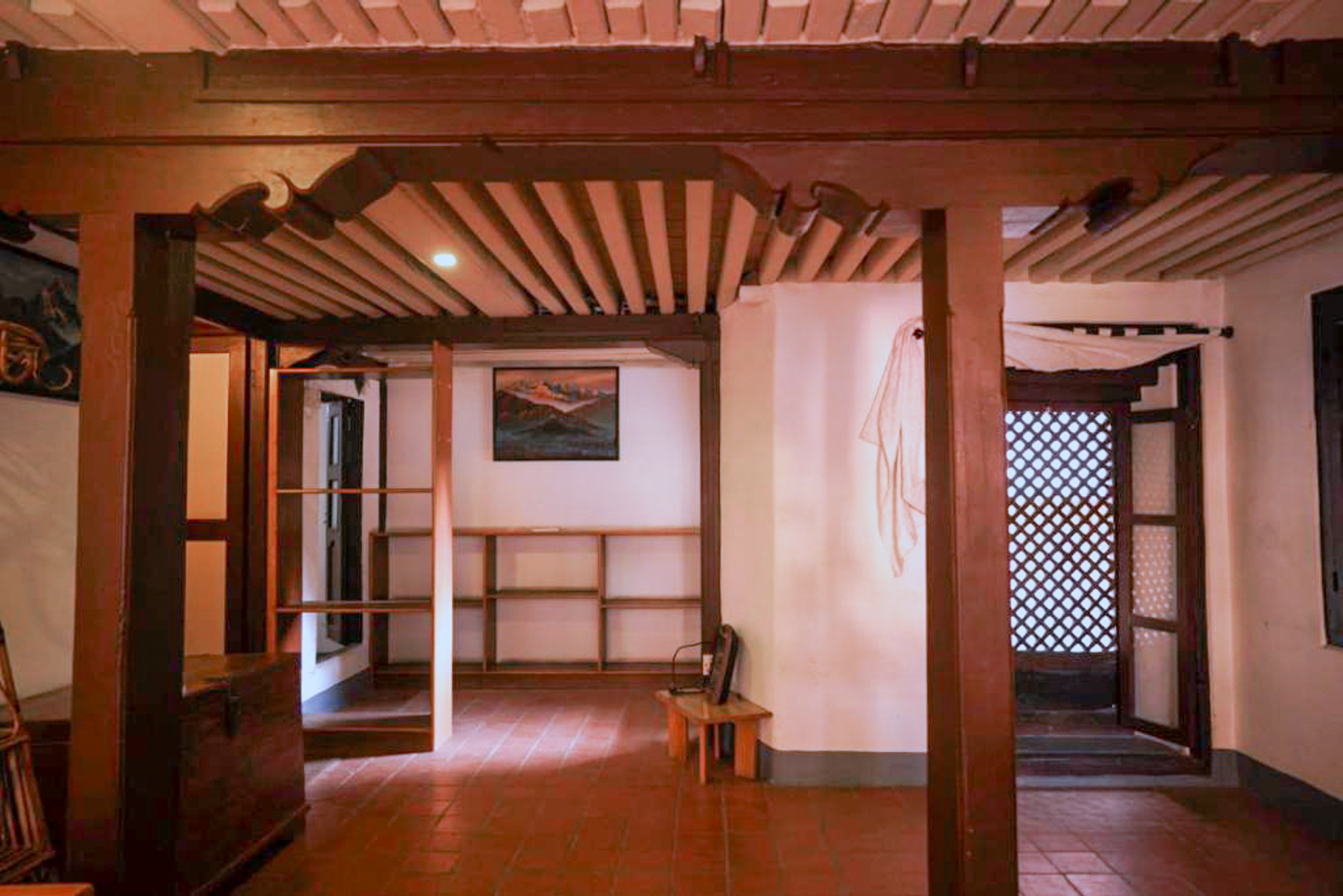 Brahmayani room entrance and timber bench beneath exposed beams